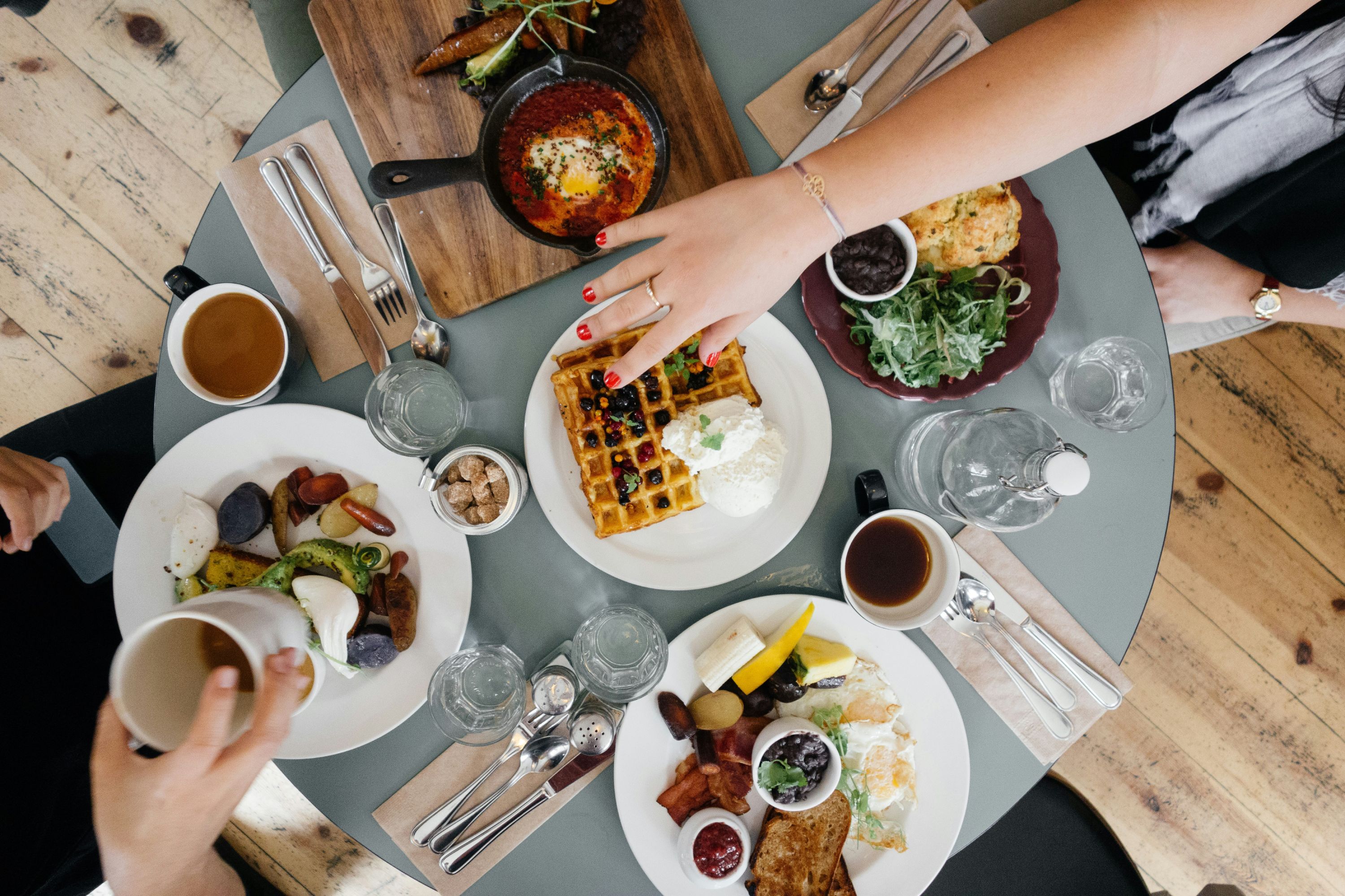Top down view of small table full of breakfast foods
