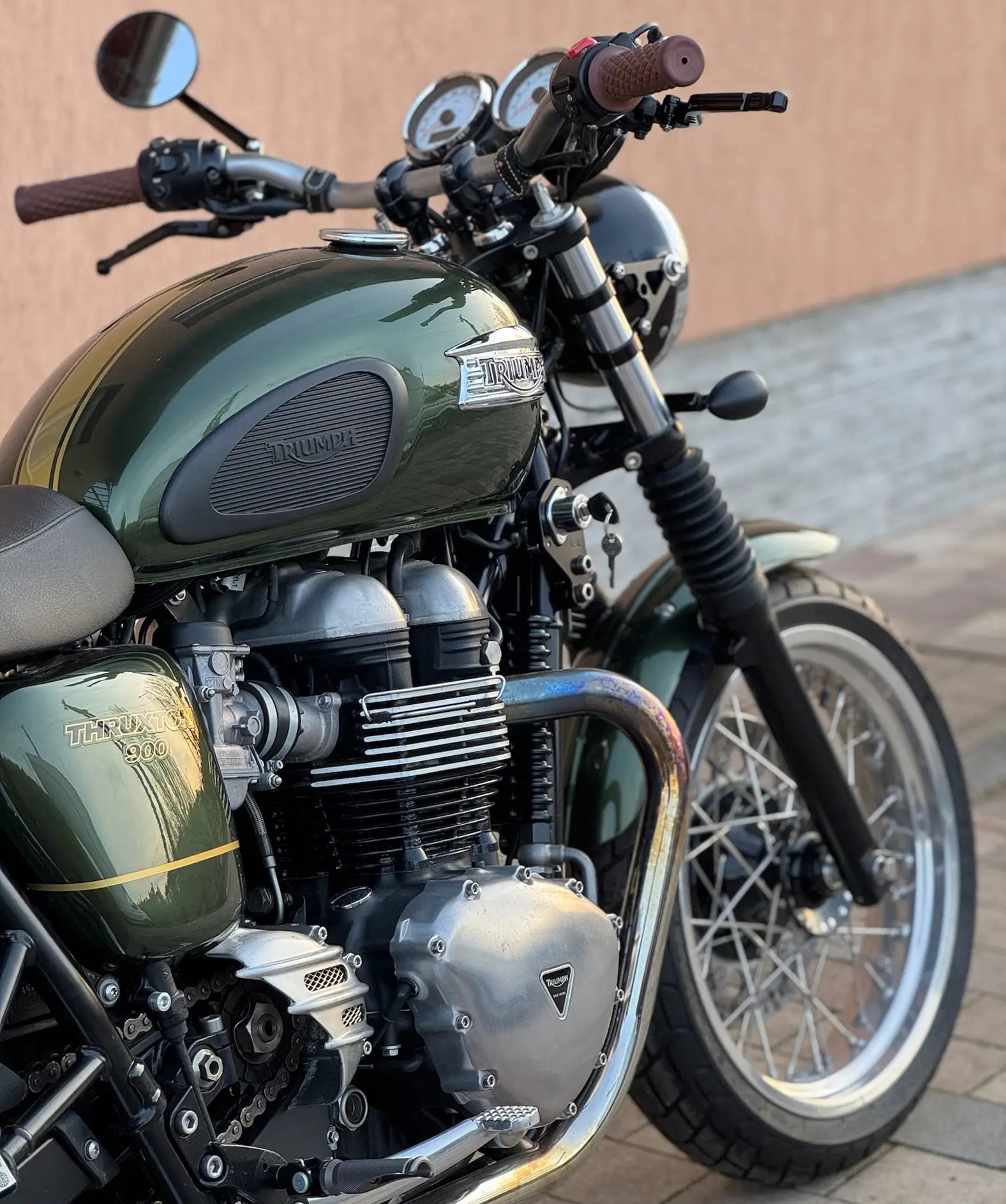A dark green motorcycle in great conditions.