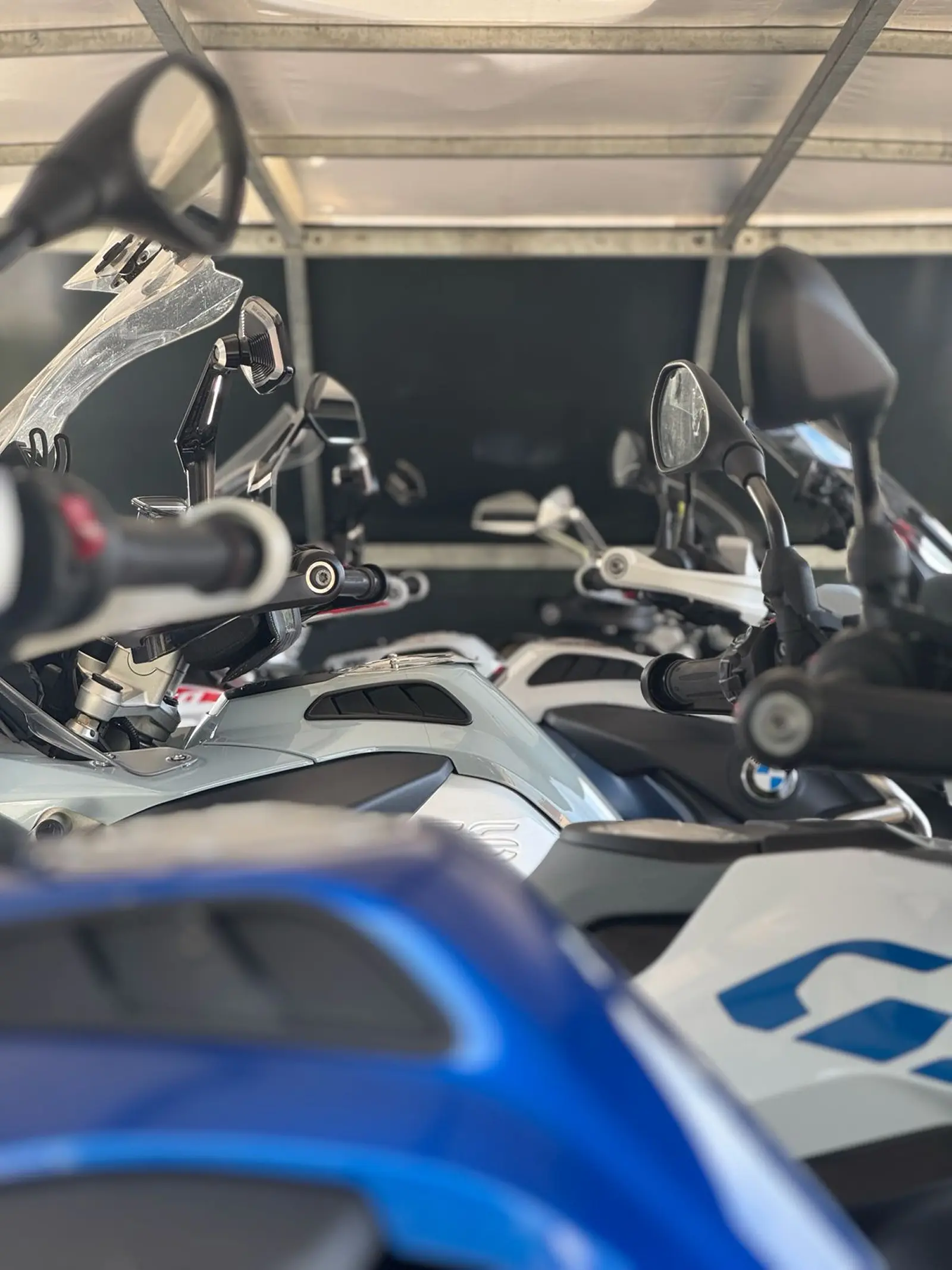 Six motorcycles securely fastened inside an enclosed trailer.