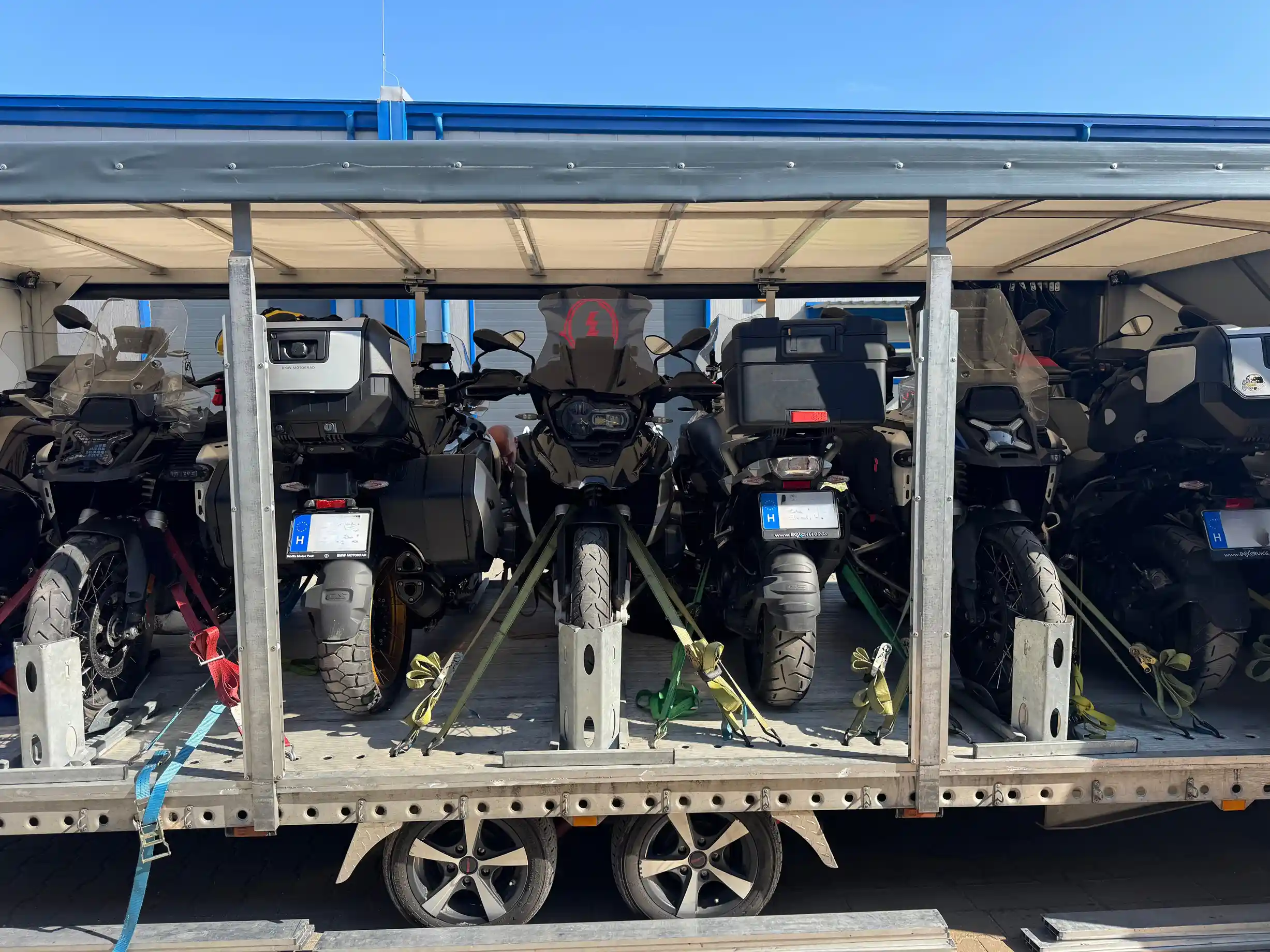 Six motorcycles secured in the trailer, ready for the road.