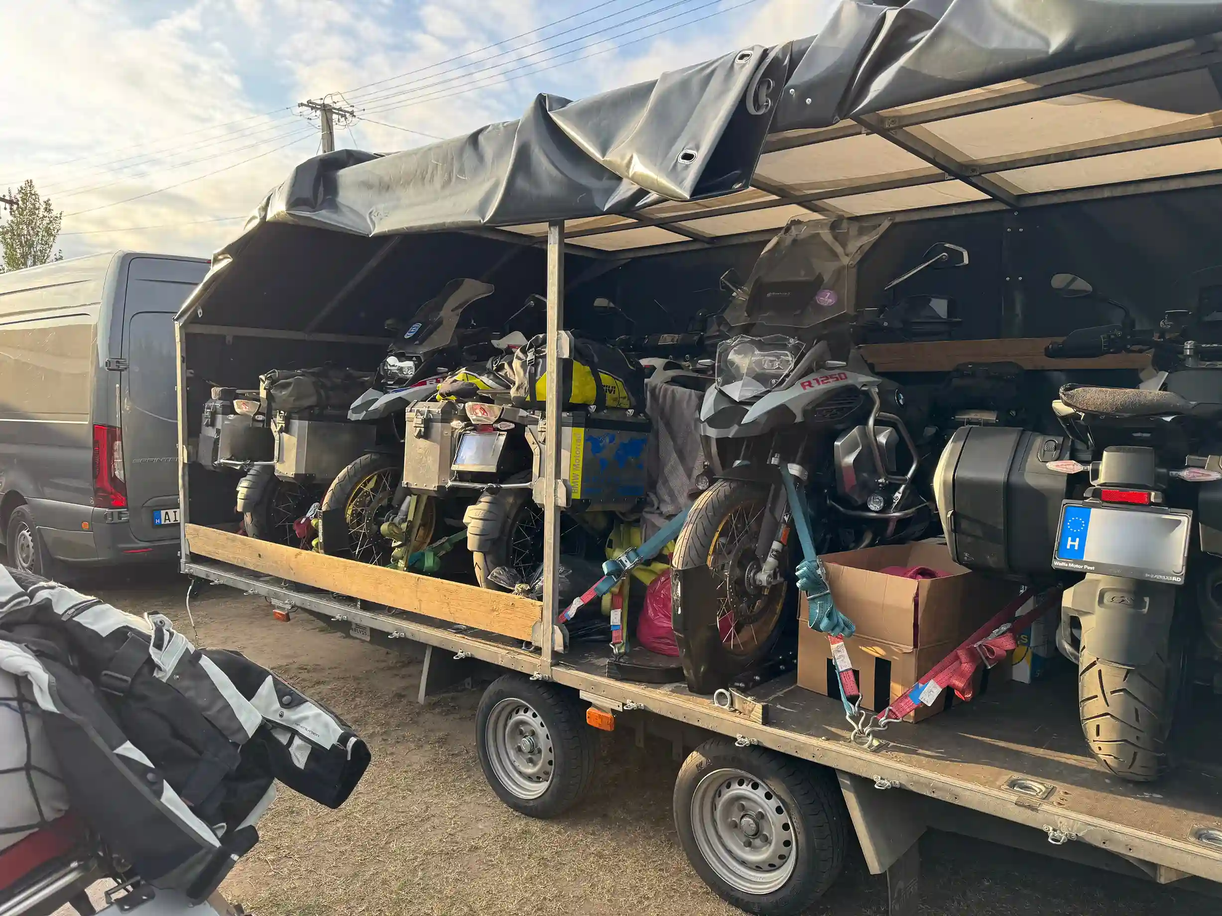 Five motorcycles and gear securely fastened in an enclosed trailer.
