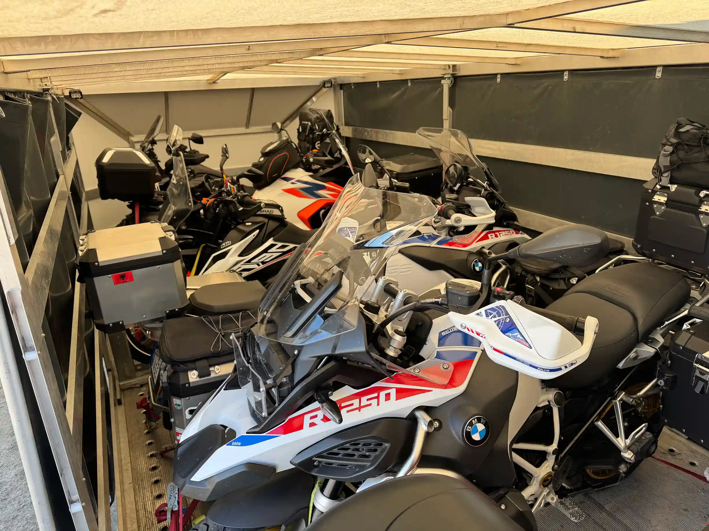 Five motorcycles secured in the enclosed trailer.