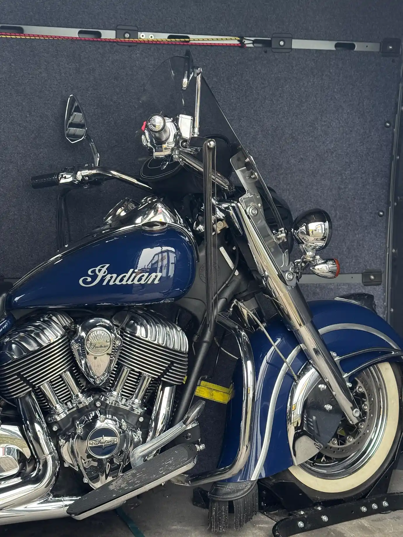 One blue motorcycle securely fastened inside the van.