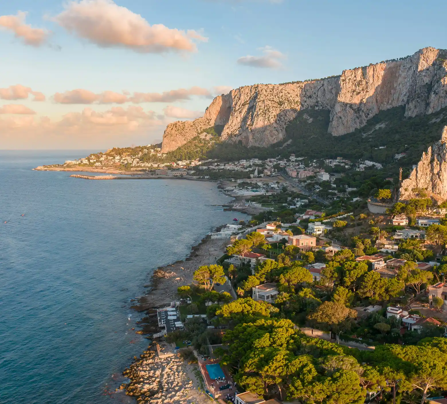 Coastal city with mountains in the background.
