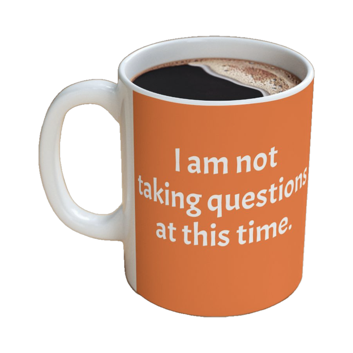 Orange mug reading "I am not taking questions at this time."
