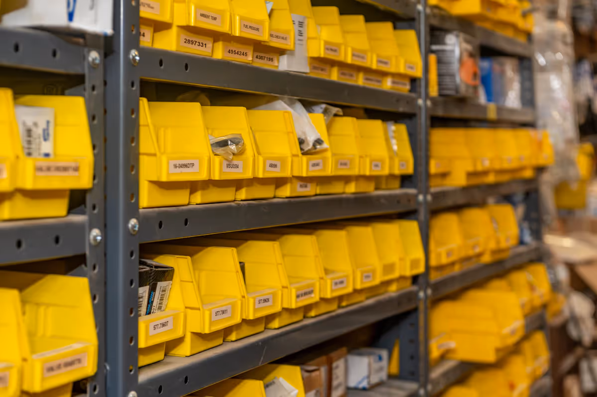 Rows of shelved yellow sorting boxes