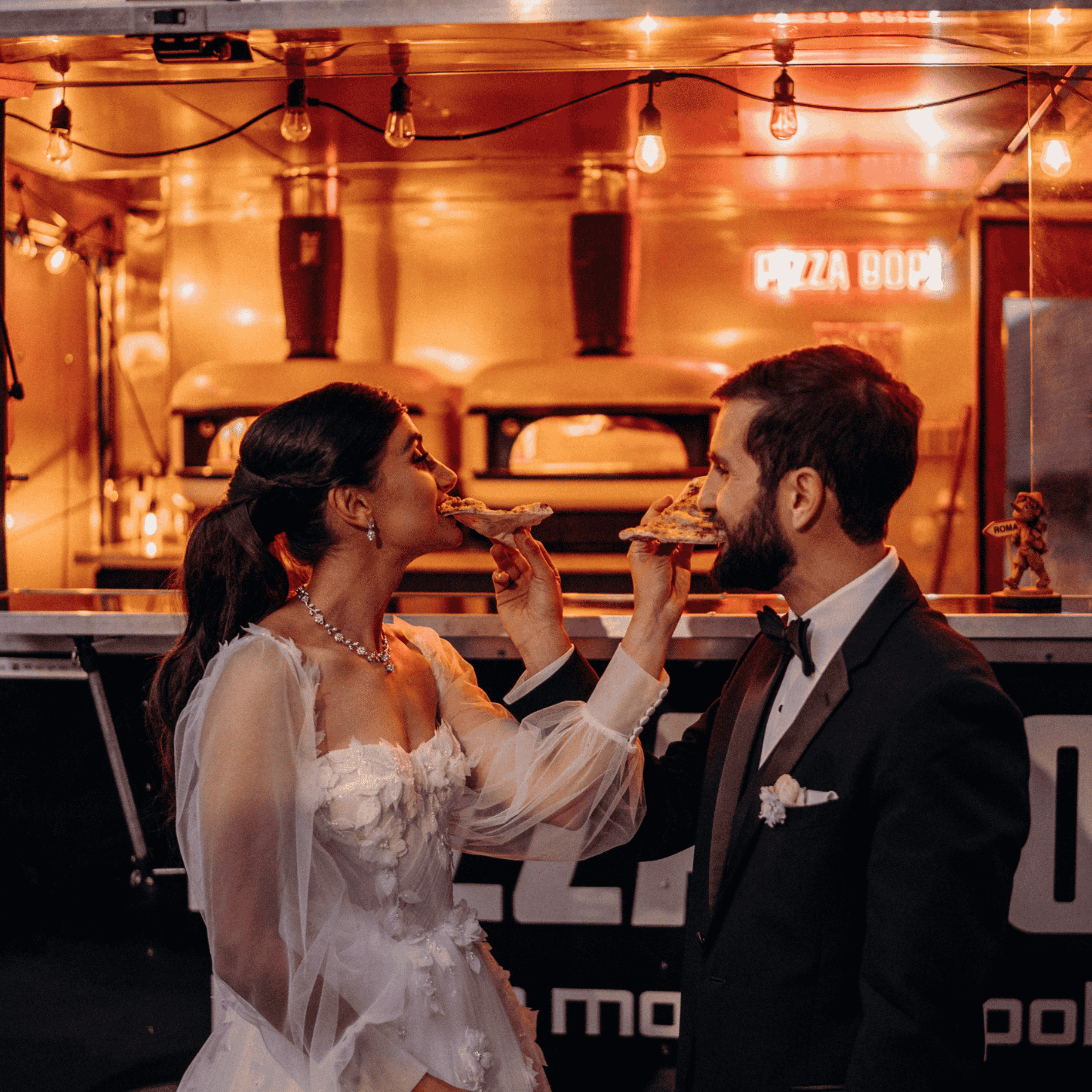 Bride and Groom eating a slice of pizzabop pizza