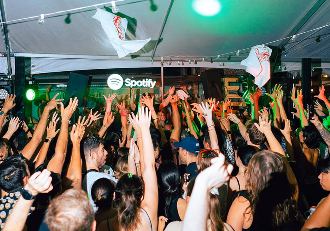 Lively crowd and party atmosphere during a Spotify event at Roberta’s Pizza restaurant.
