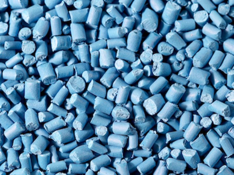 Blue polypropylene resin pellets close-up industrial grade