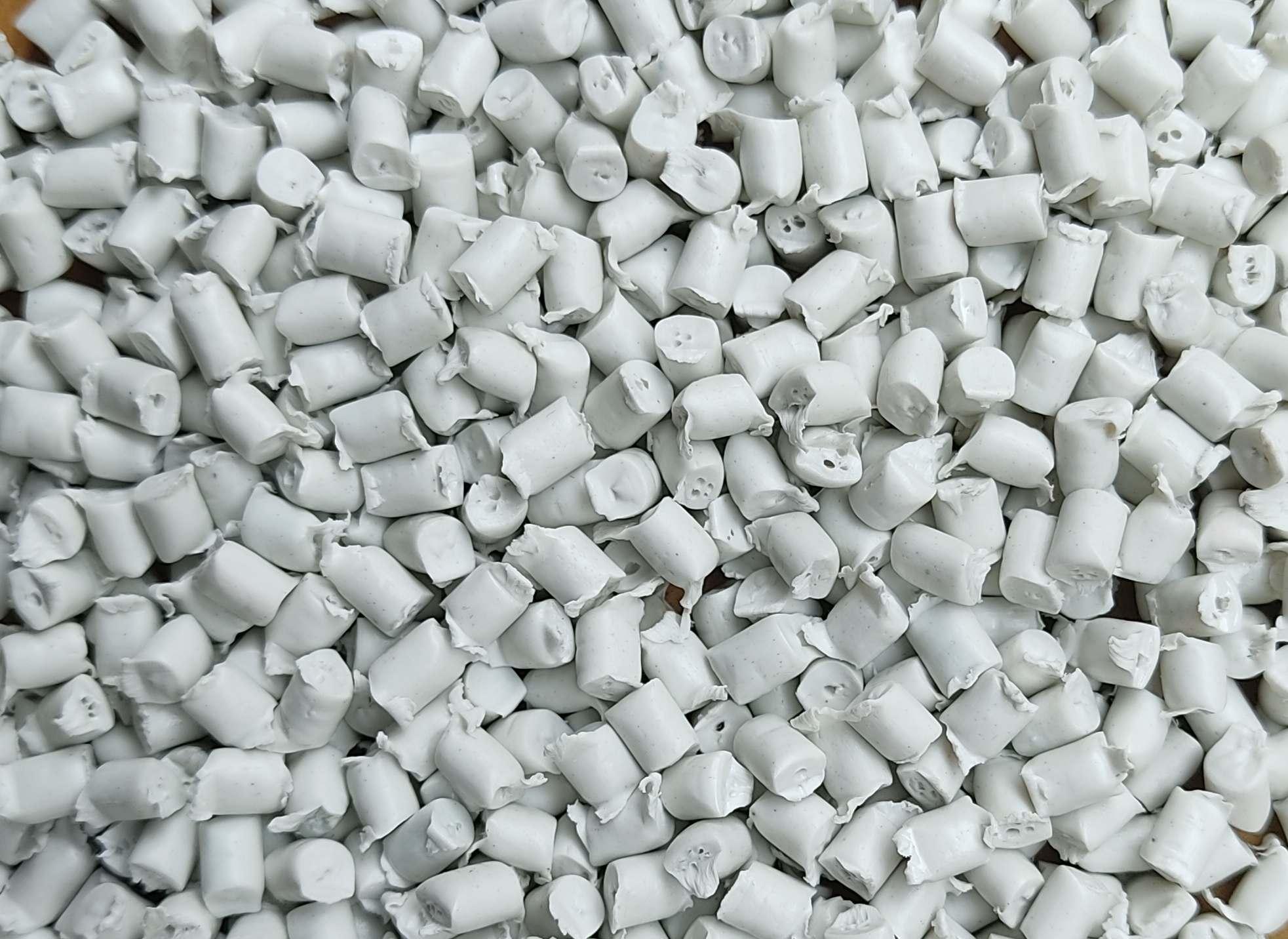 White plastic resin pellets prepared for industrial manufacturing