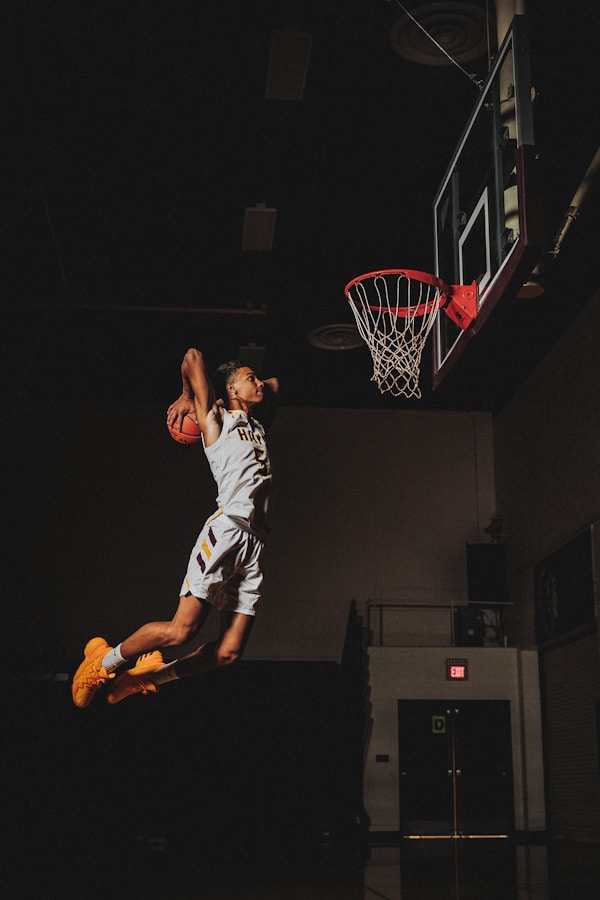 2 boys playing basketball on basketball court