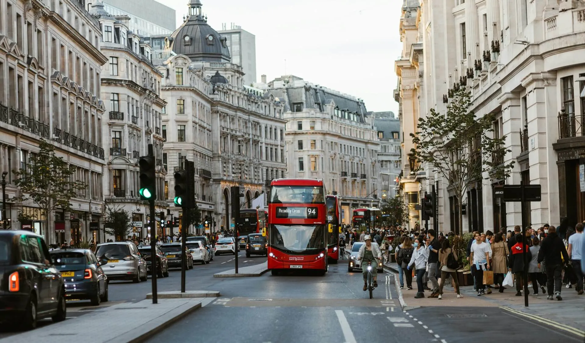 a red double decker bus driving down