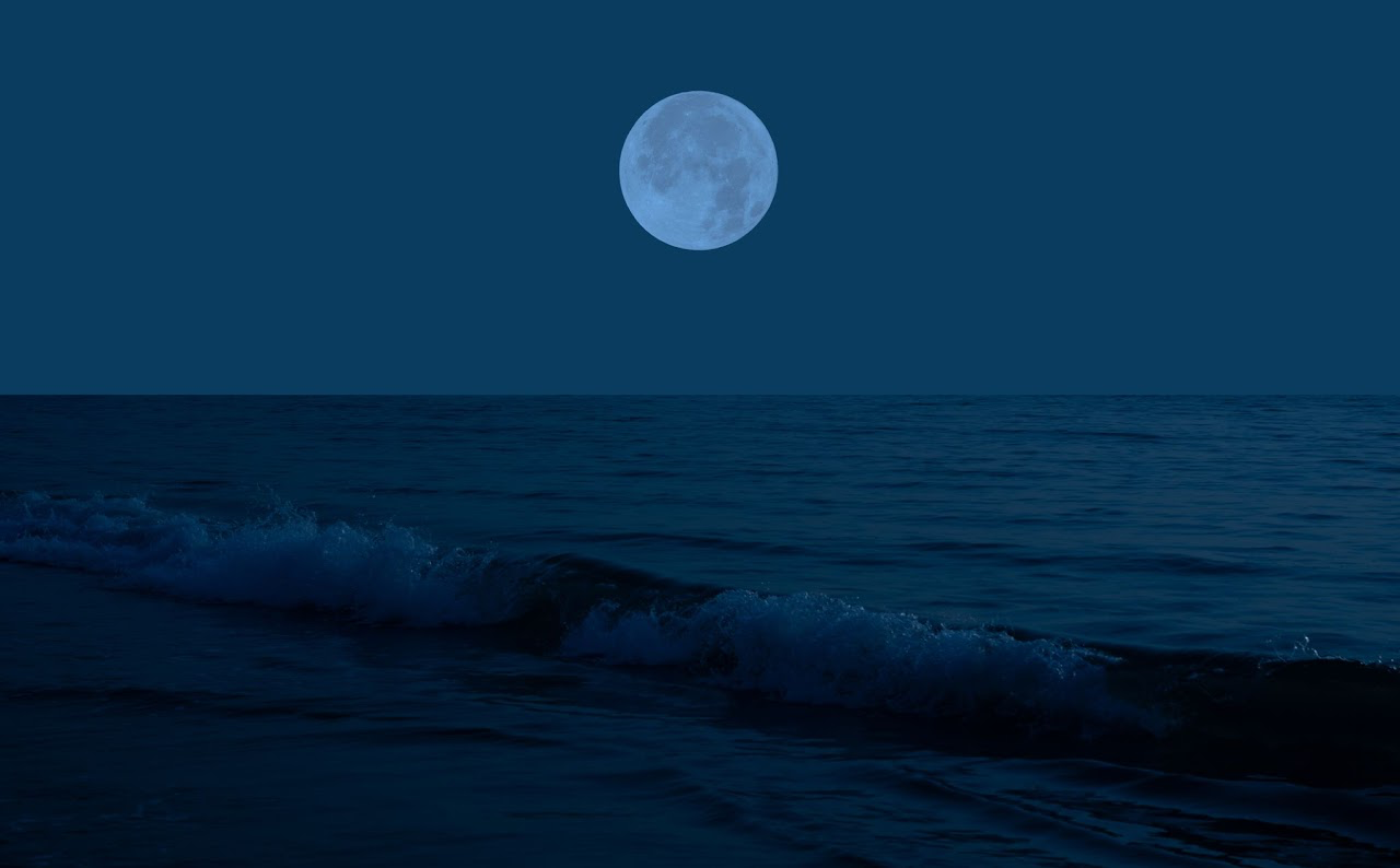 A moon over the oceanDescription automatically generated