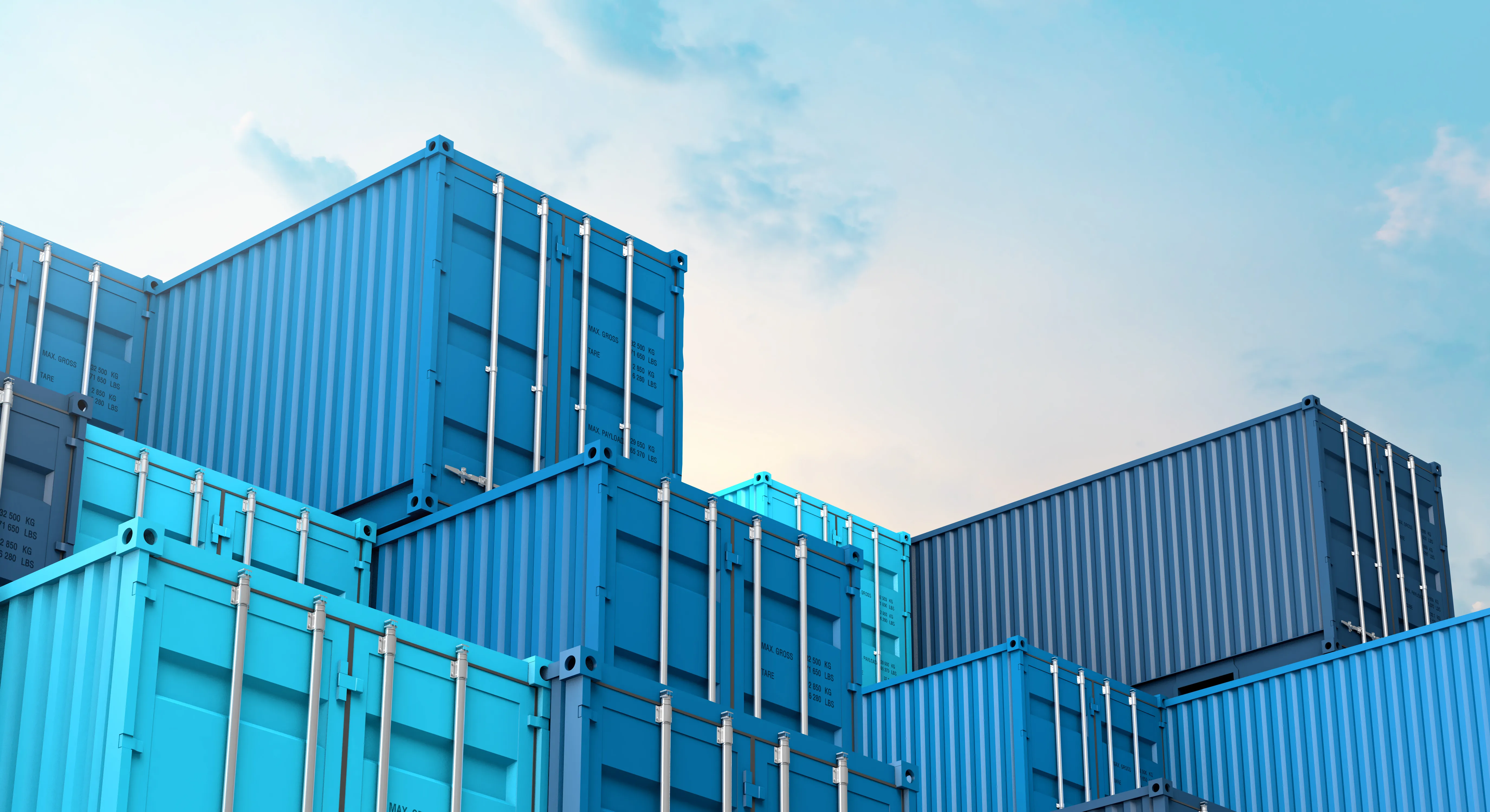 Stacked blue shipping containers against a clear sky.