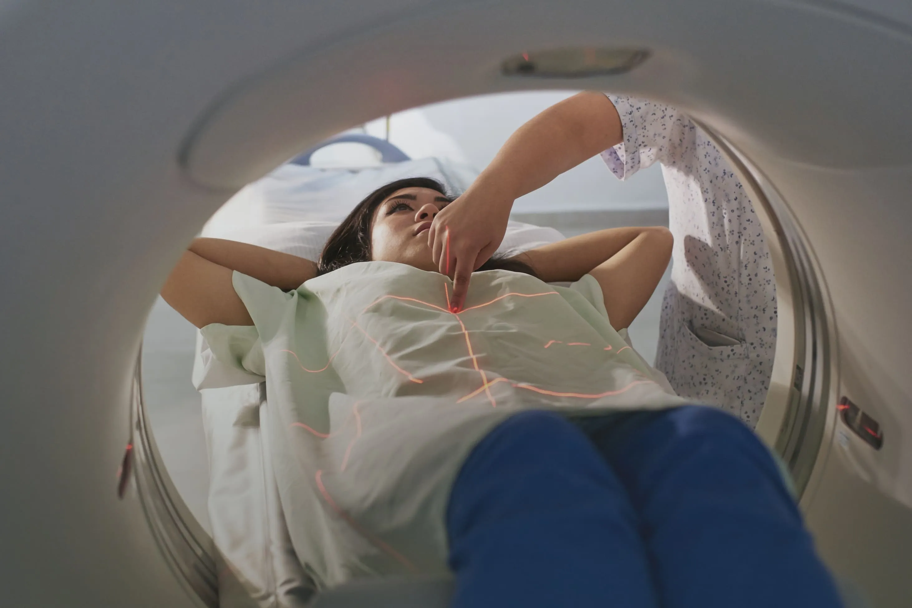 Patient lies in an MRI machine's bore, preparing to be scanned.