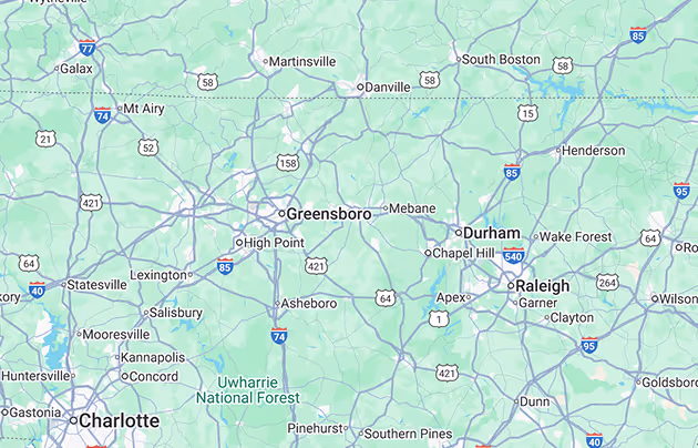 Map of Central North Carolina showing cities including Charlotte, Greensboro, Durham, and Raleigh, with highways and national forest areas.