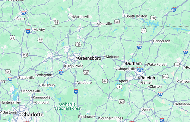Map of Central North Carolina showing cities including Charlotte, Greensboro, Durham, and Raleigh, with highways and national forest areas.