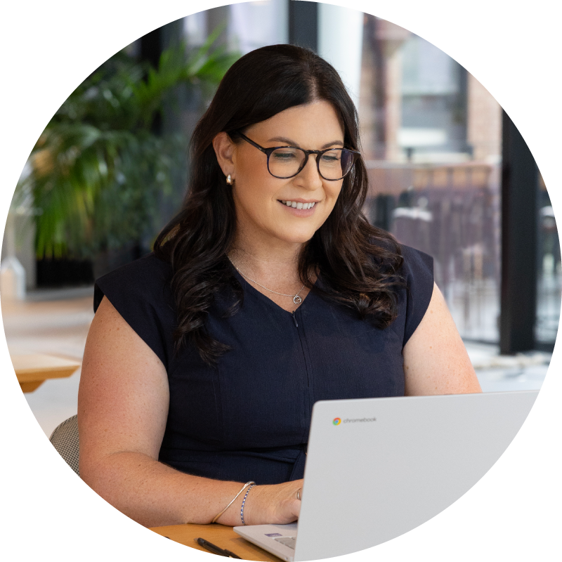 Silhouettes of two people sitting and facing each other in a softly lit room with large windows.