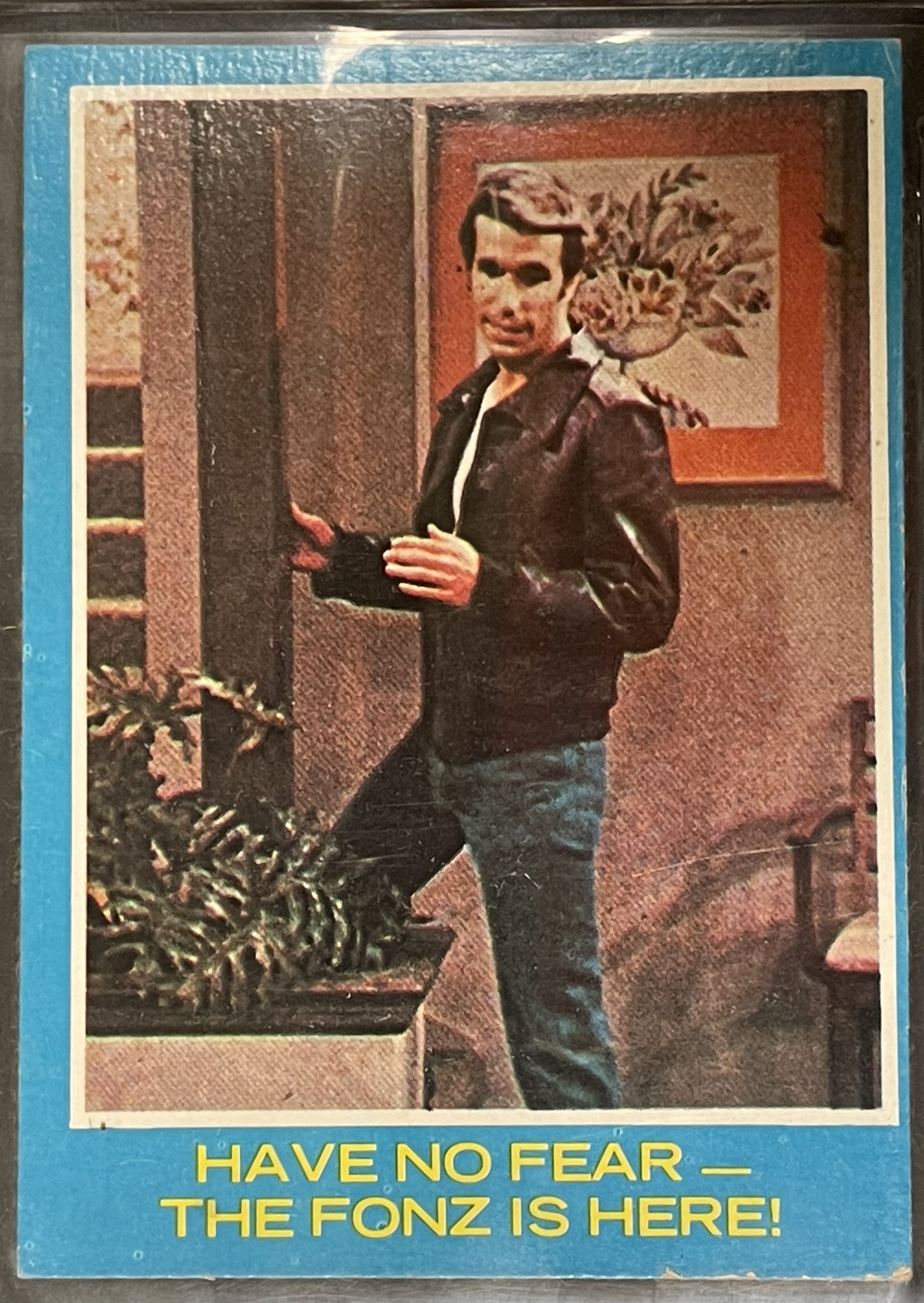 Costume sketch of a clown-like figure with a round beige torso, orange-striped sleeves, oversized purple pants, yellow gloves, and large yellow shoes.