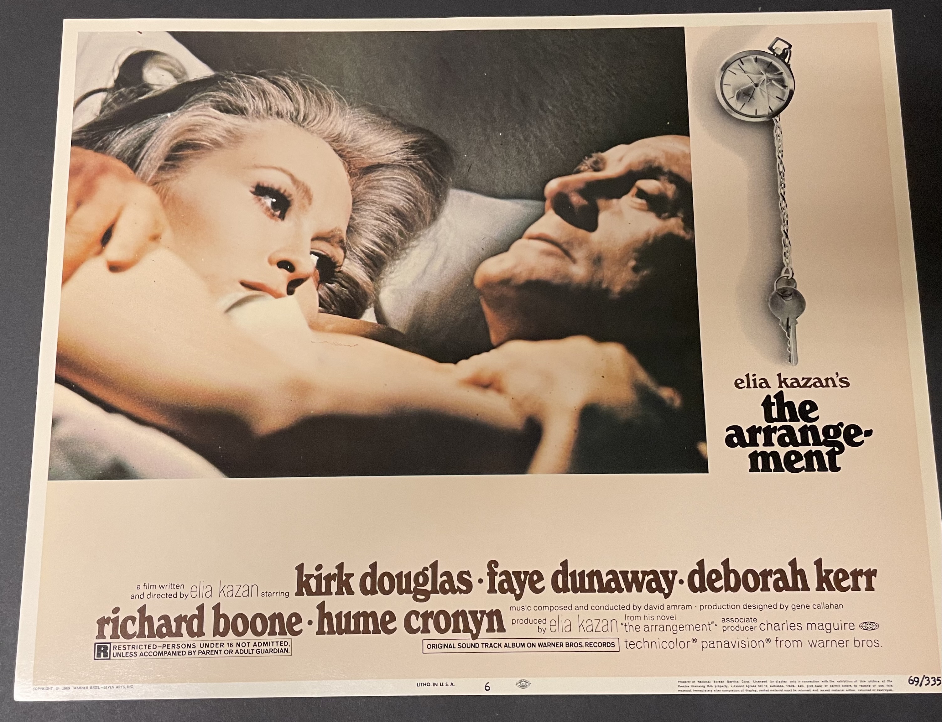 Costume sketch of a clown-like figure with a round beige torso, orange-striped sleeves, oversized purple pants, yellow gloves, and large yellow shoes.