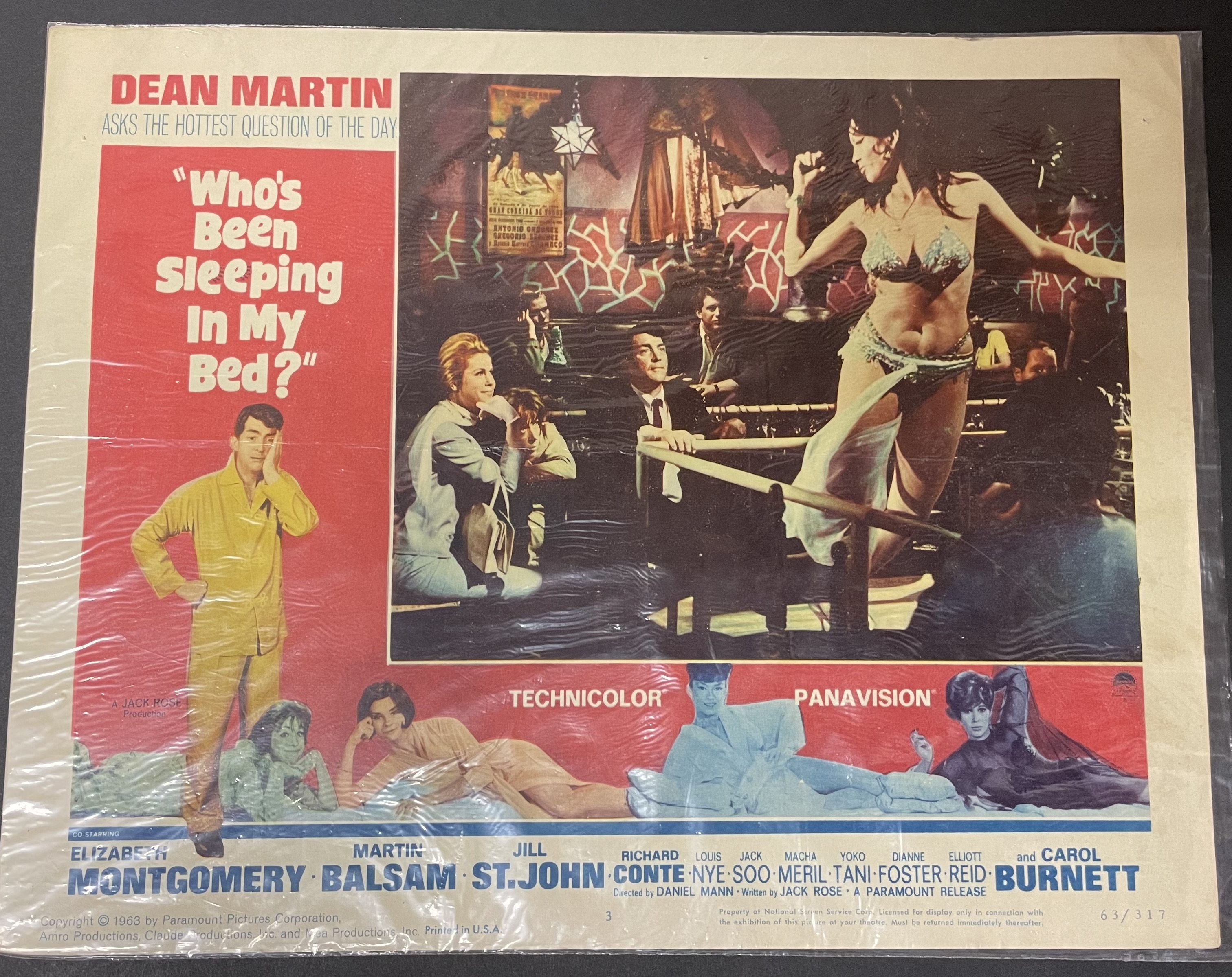 Costume sketch of a clown-like figure with a round beige torso, orange-striped sleeves, oversized purple pants, yellow gloves, and large yellow shoes.