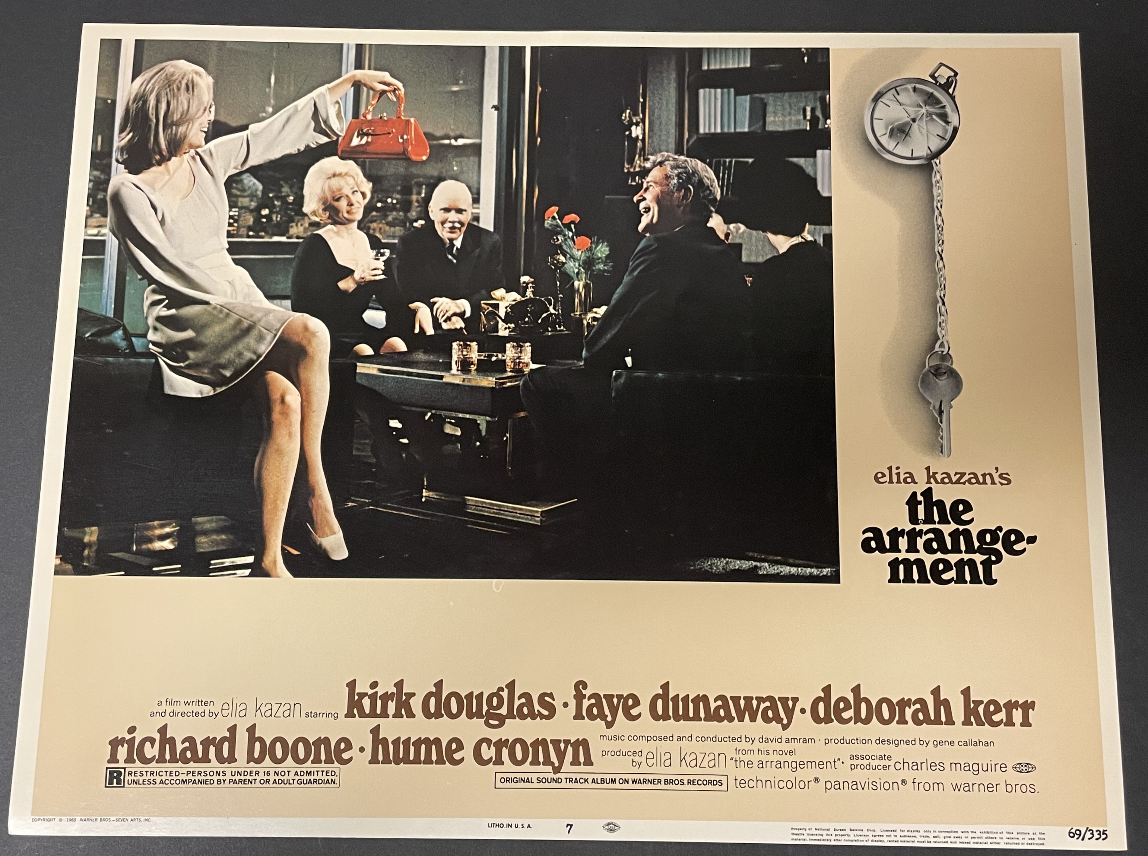 Costume sketch of a clown-like figure with a round beige torso, orange-striped sleeves, oversized purple pants, yellow gloves, and large yellow shoes.