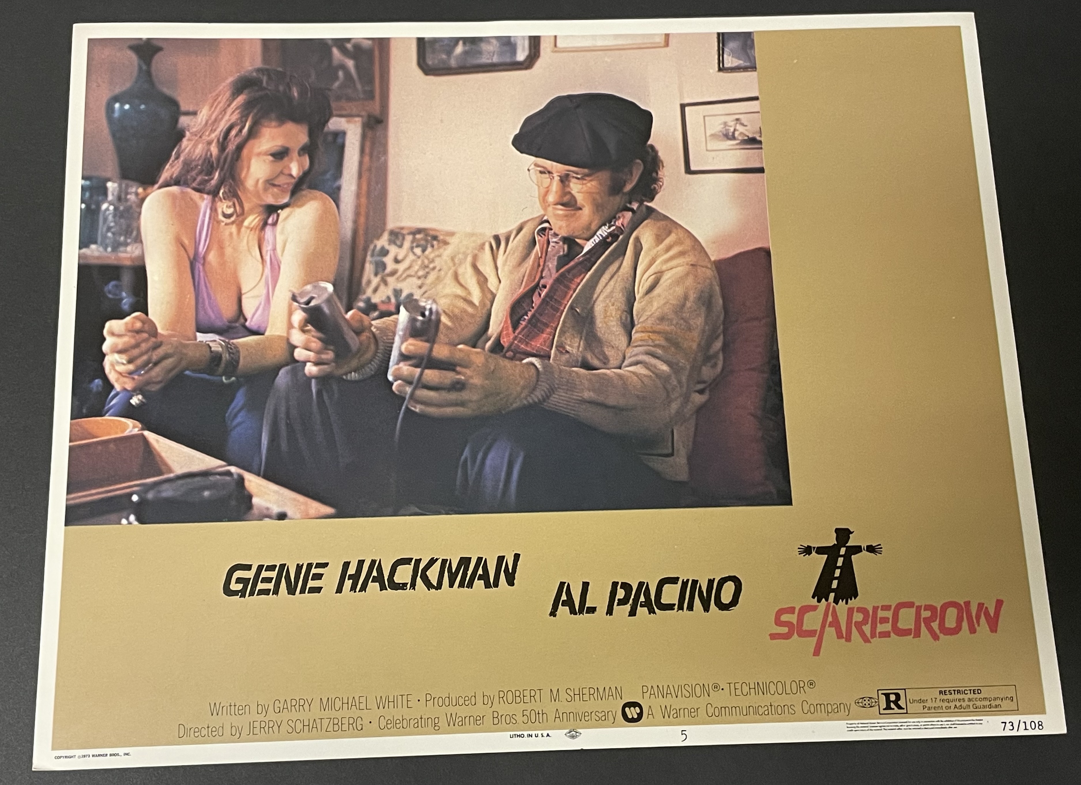 Costume sketch of a clown-like figure with a round beige torso, orange-striped sleeves, oversized purple pants, yellow gloves, and large yellow shoes.