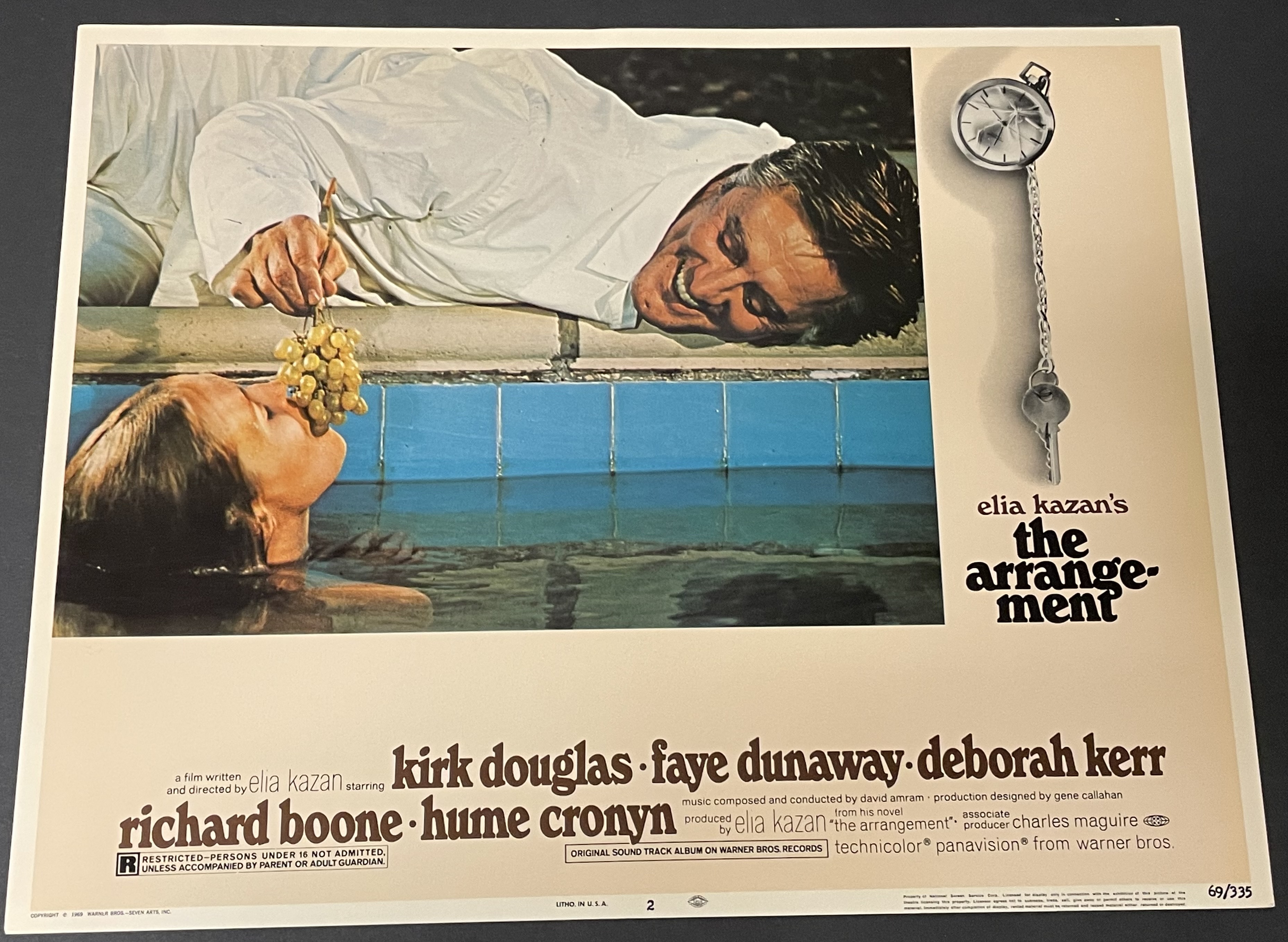 Costume sketch of a clown-like figure with a round beige torso, orange-striped sleeves, oversized purple pants, yellow gloves, and large yellow shoes.