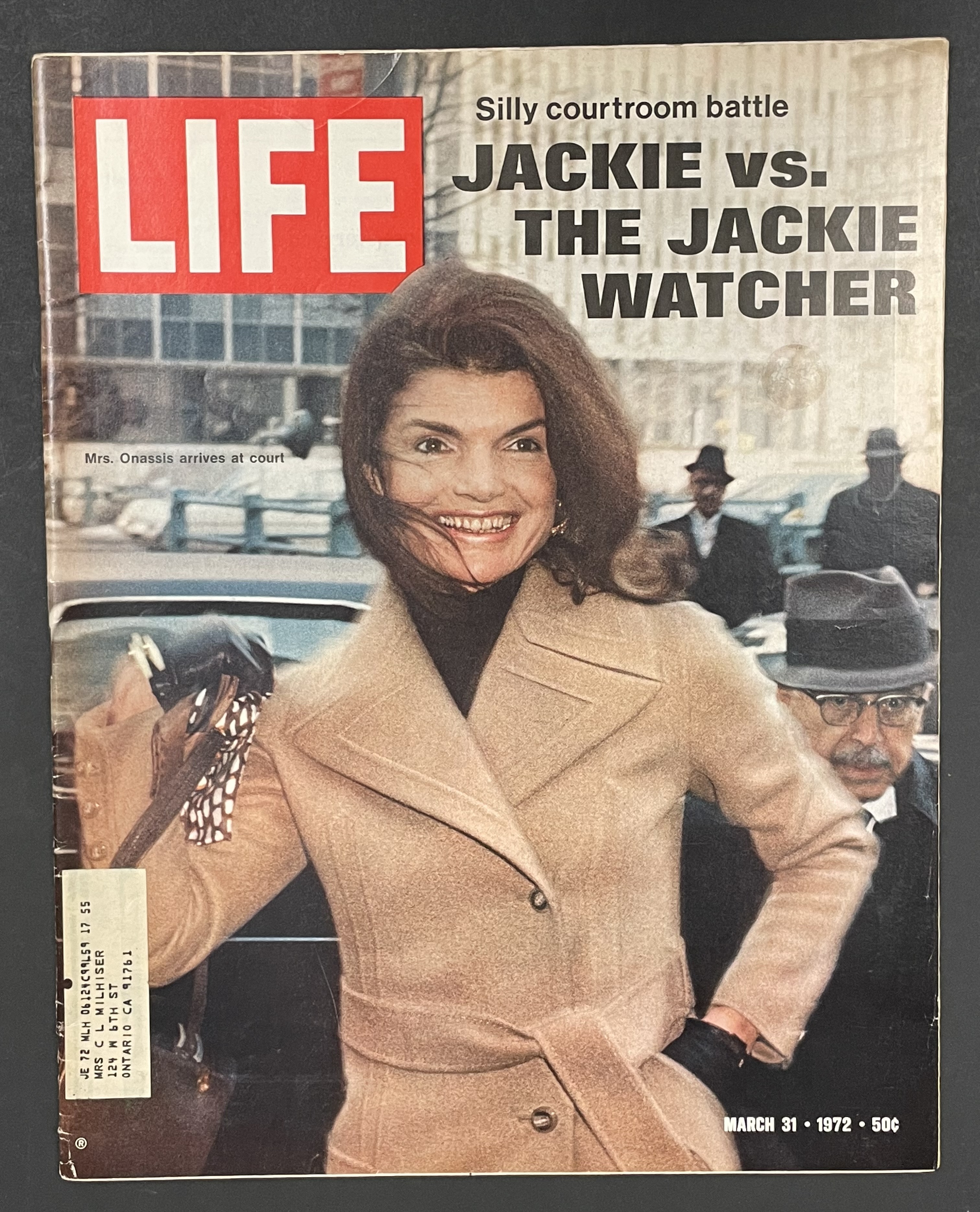 Costume sketch of a clown-like figure with a round beige torso, orange-striped sleeves, oversized purple pants, yellow gloves, and large yellow shoes.