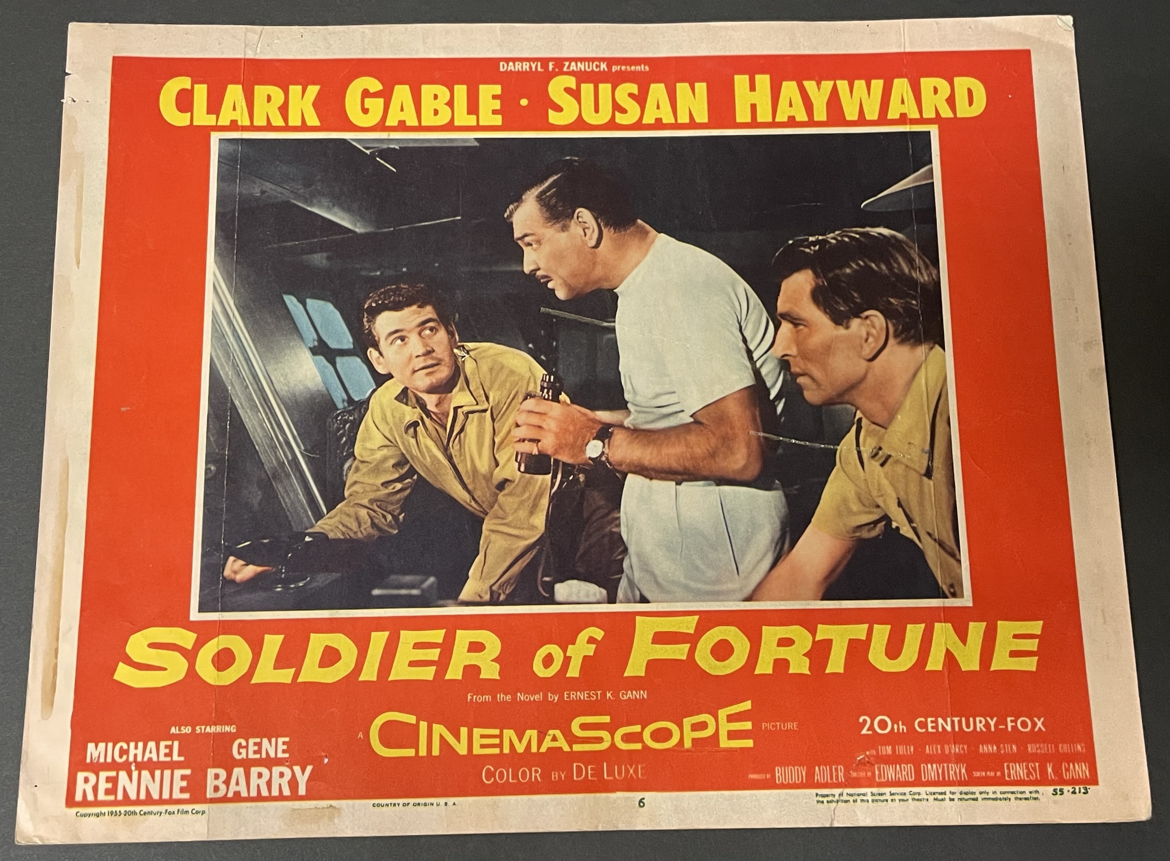 Costume sketch of a clown-like figure with a round beige torso, orange-striped sleeves, oversized purple pants, yellow gloves, and large yellow shoes.