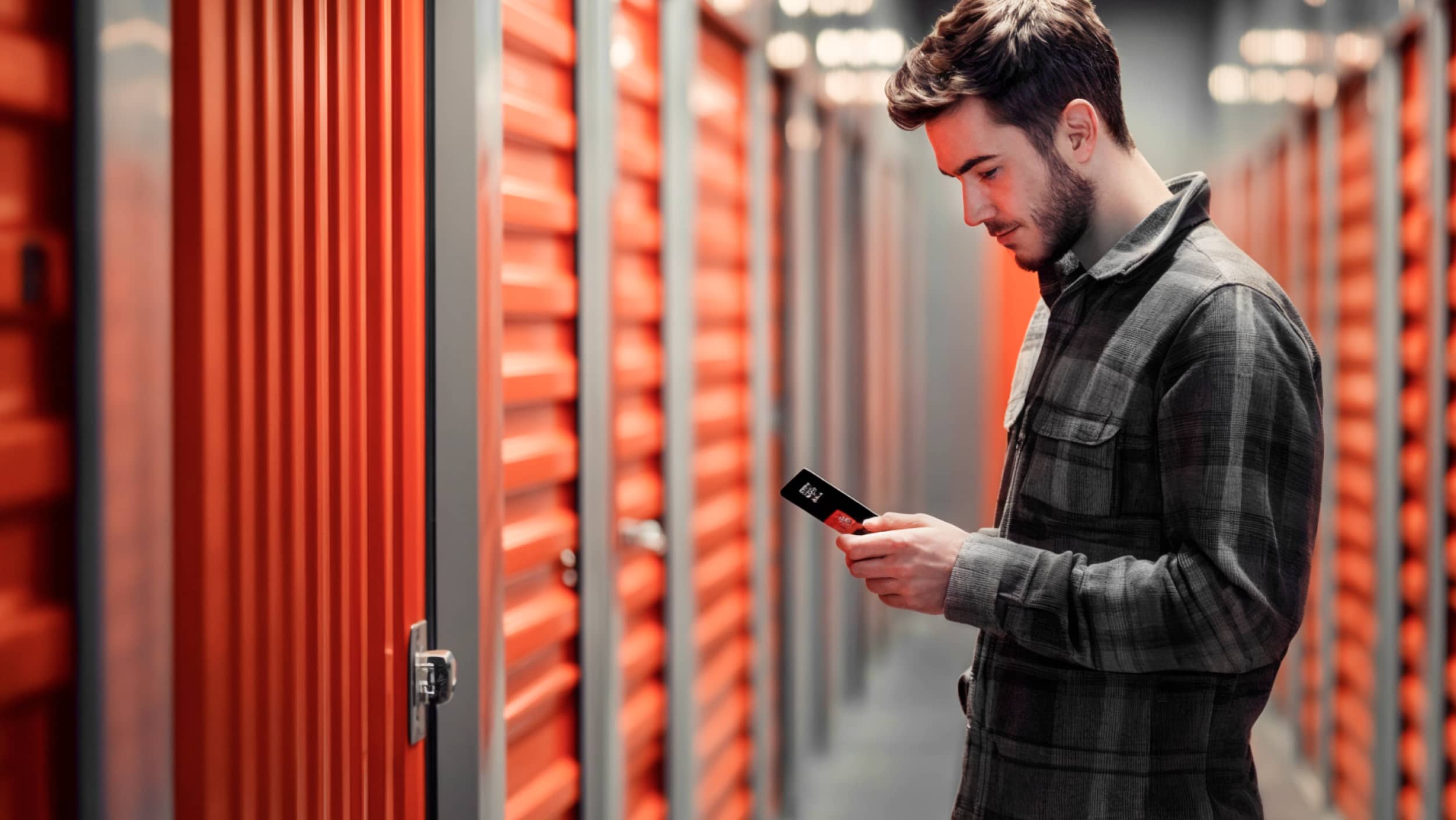Self Storage Man Checking His Phone V2 - SelfStorage X Webflow Template
