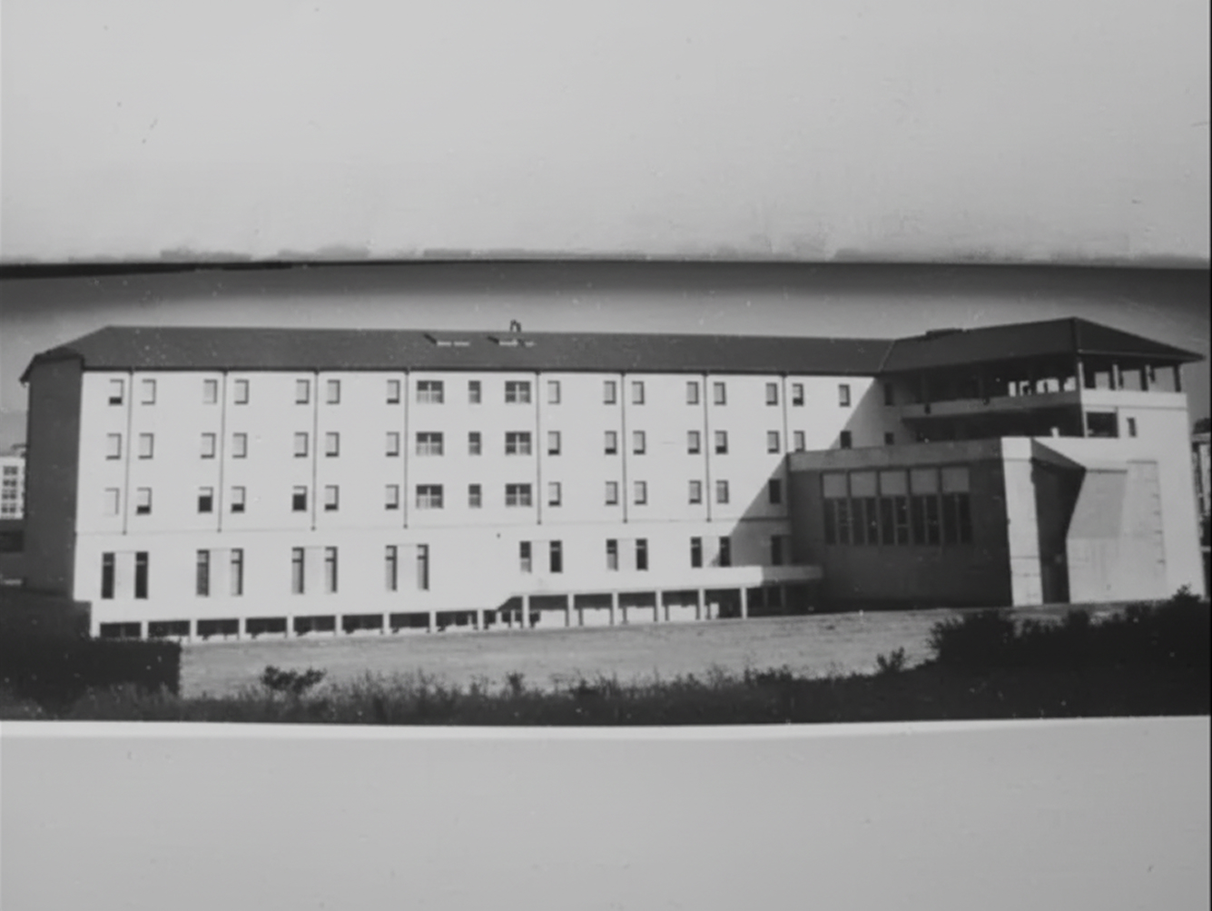 Person holding and flipping through pages of an open hymn book during a religious service.