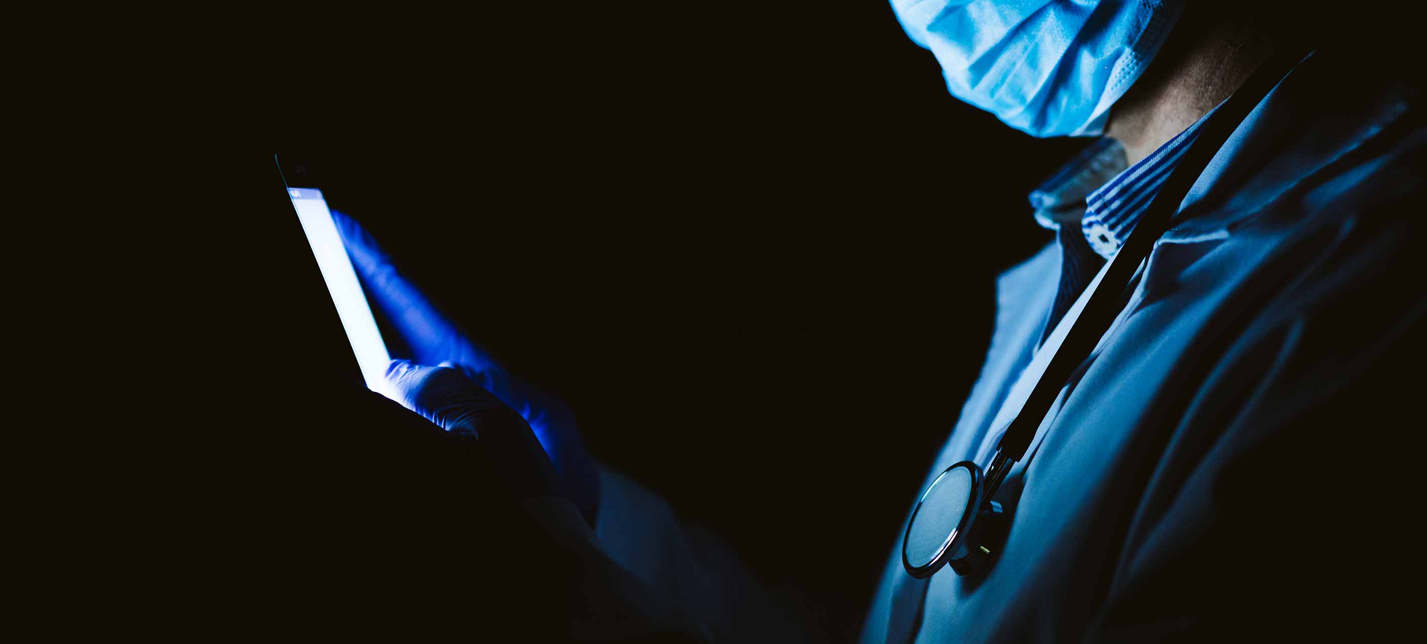 Close-up of a person wearing orange-tinted goggles and a helmet with motion blur effect on an orange background.