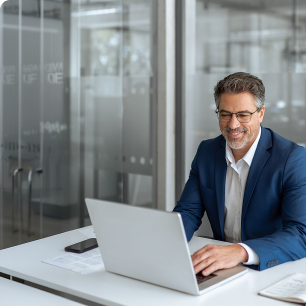 A banking professional reviewing accurate rate data on a laptop, representing Leadfusion RateSync rate consistency and compliance
