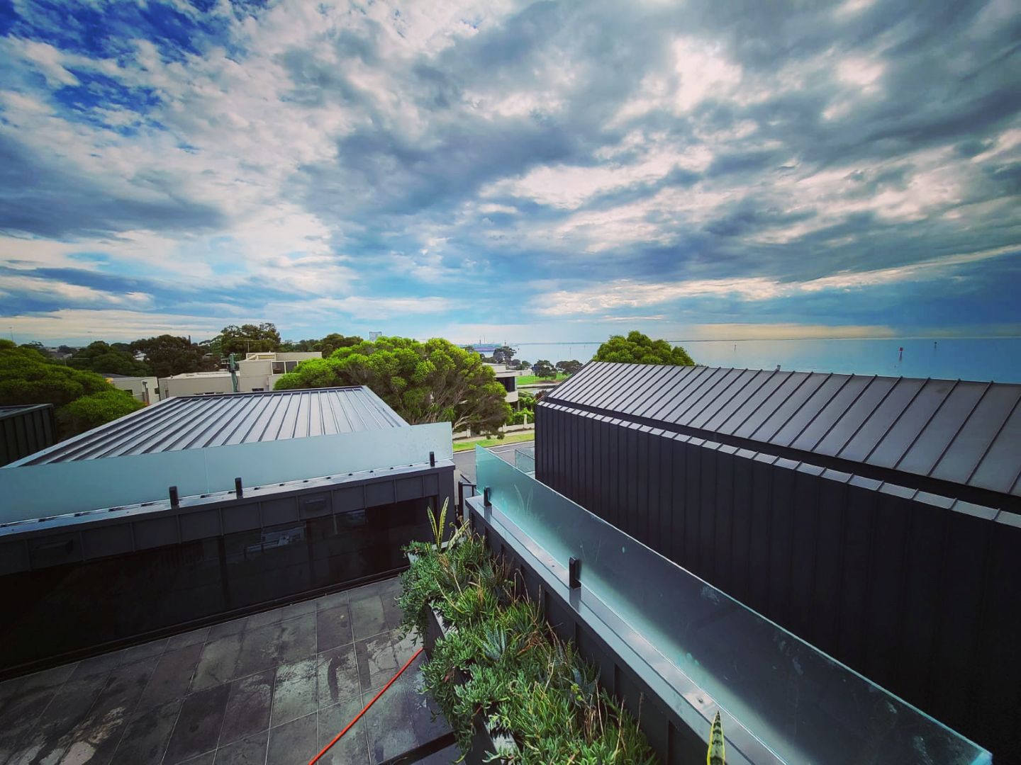 image of team in front of company building (for a roofing contractor)