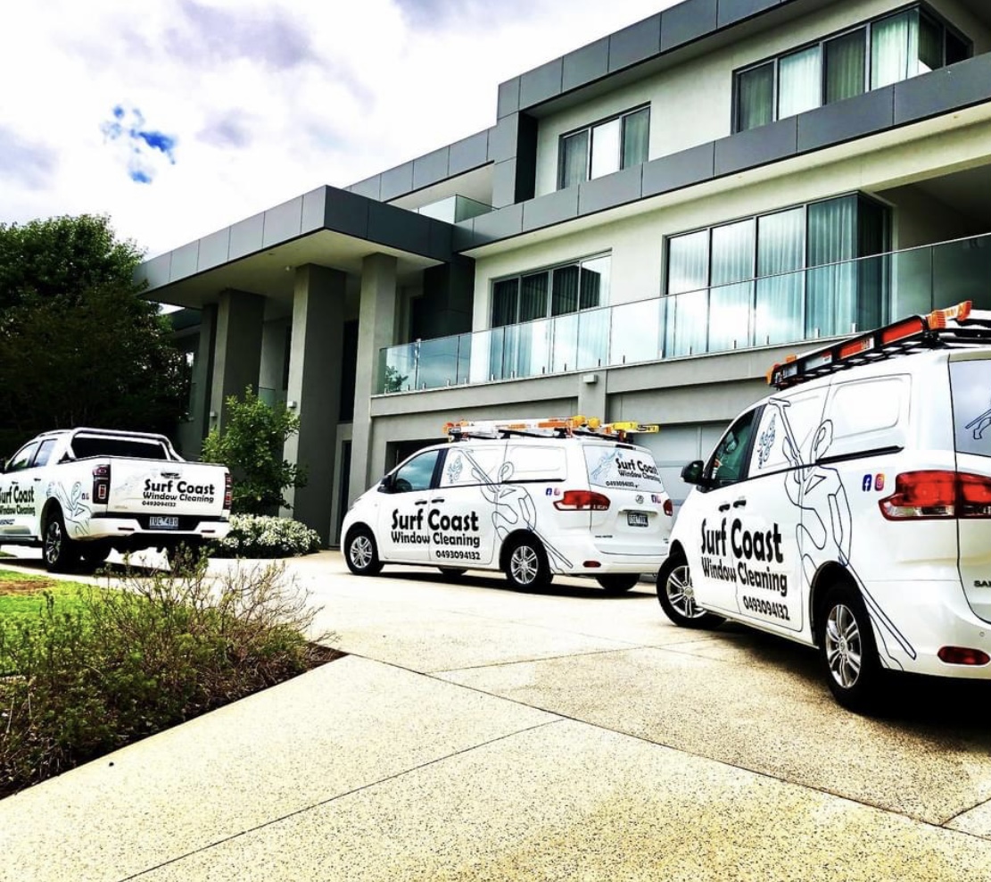 image of team in front of company building (for a roofing contractor)