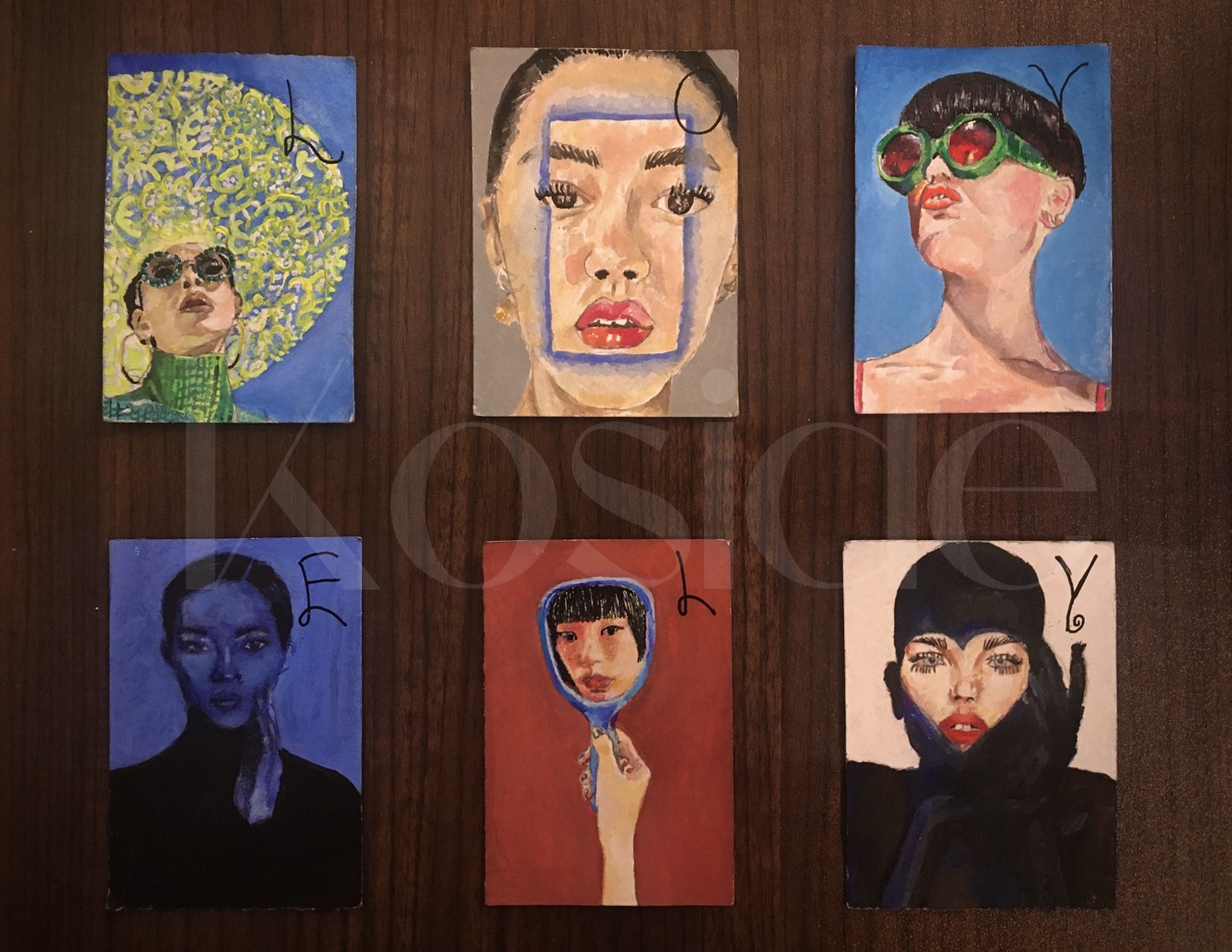 Six colorful potrait paintings of women featuring unique styles and expressions arranged. The cards make the word "LOVELY"