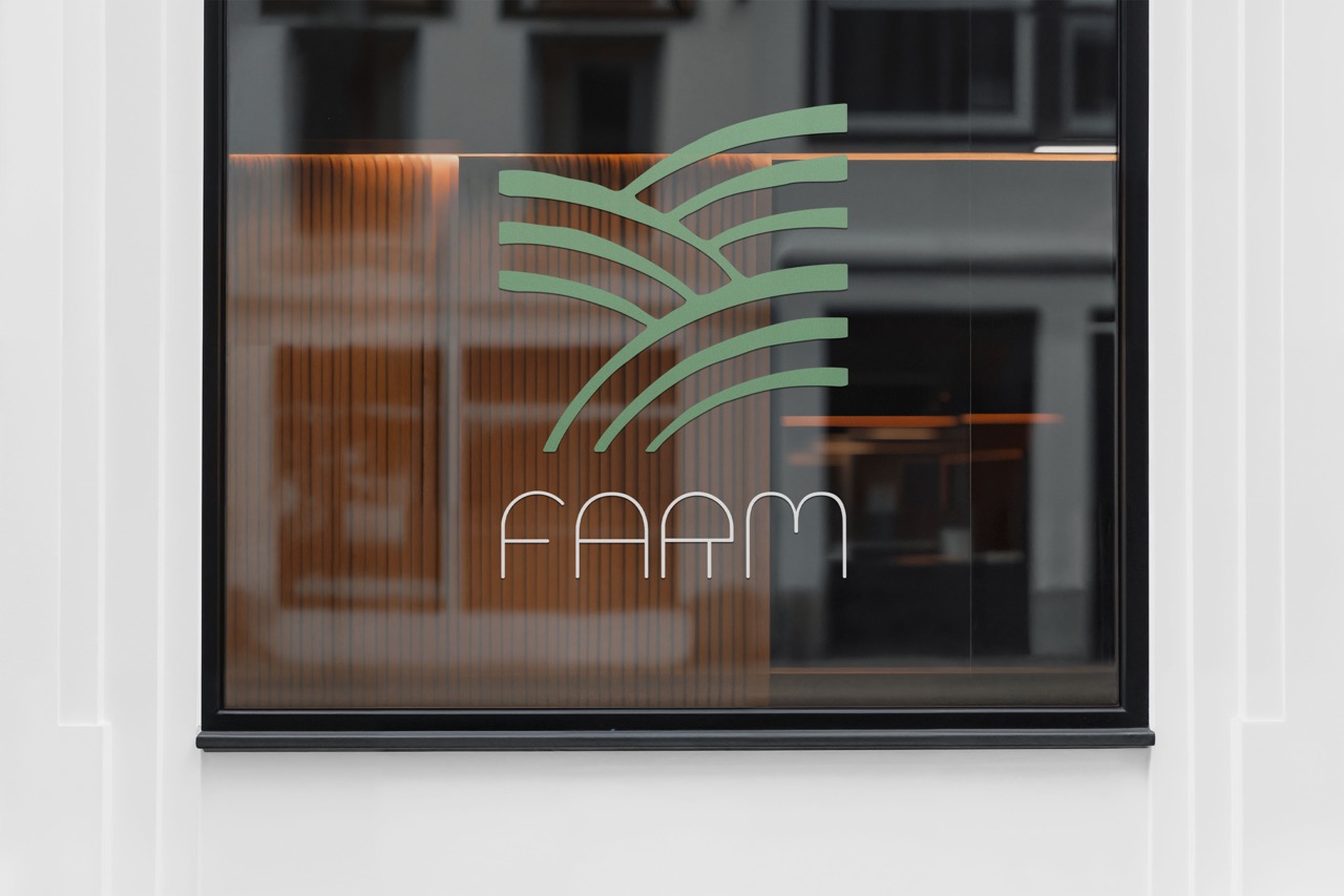 Window with a green farm logo featuring organic fields and the word ‘FARM’ below.