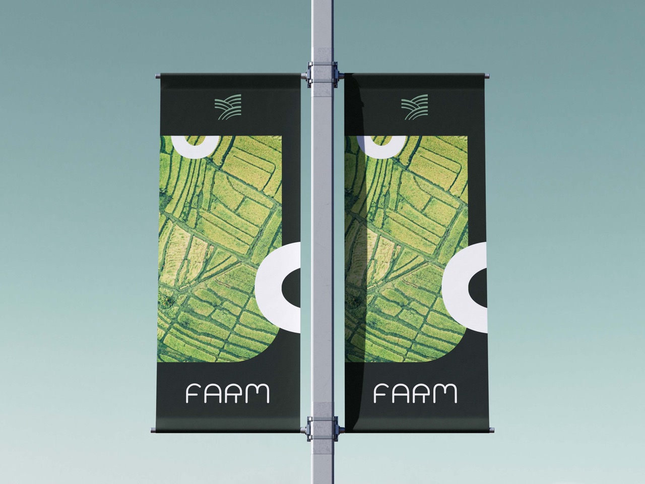 Two vertical banners on a pole featuring an aerial view of farmland with green fields and the brand 'FARM' below.
