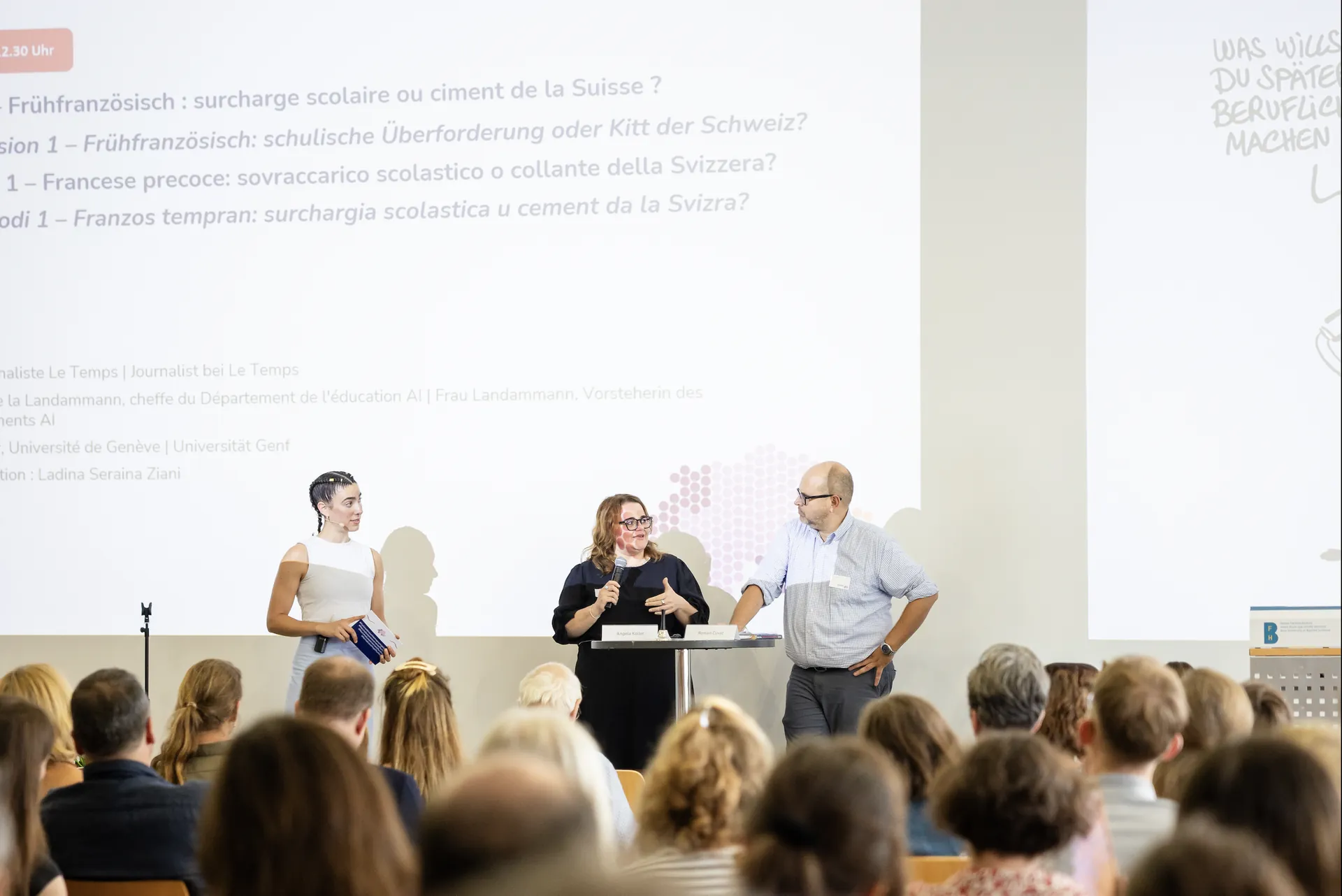 Ladina Ziani moderating a panel discussion in front of an audience