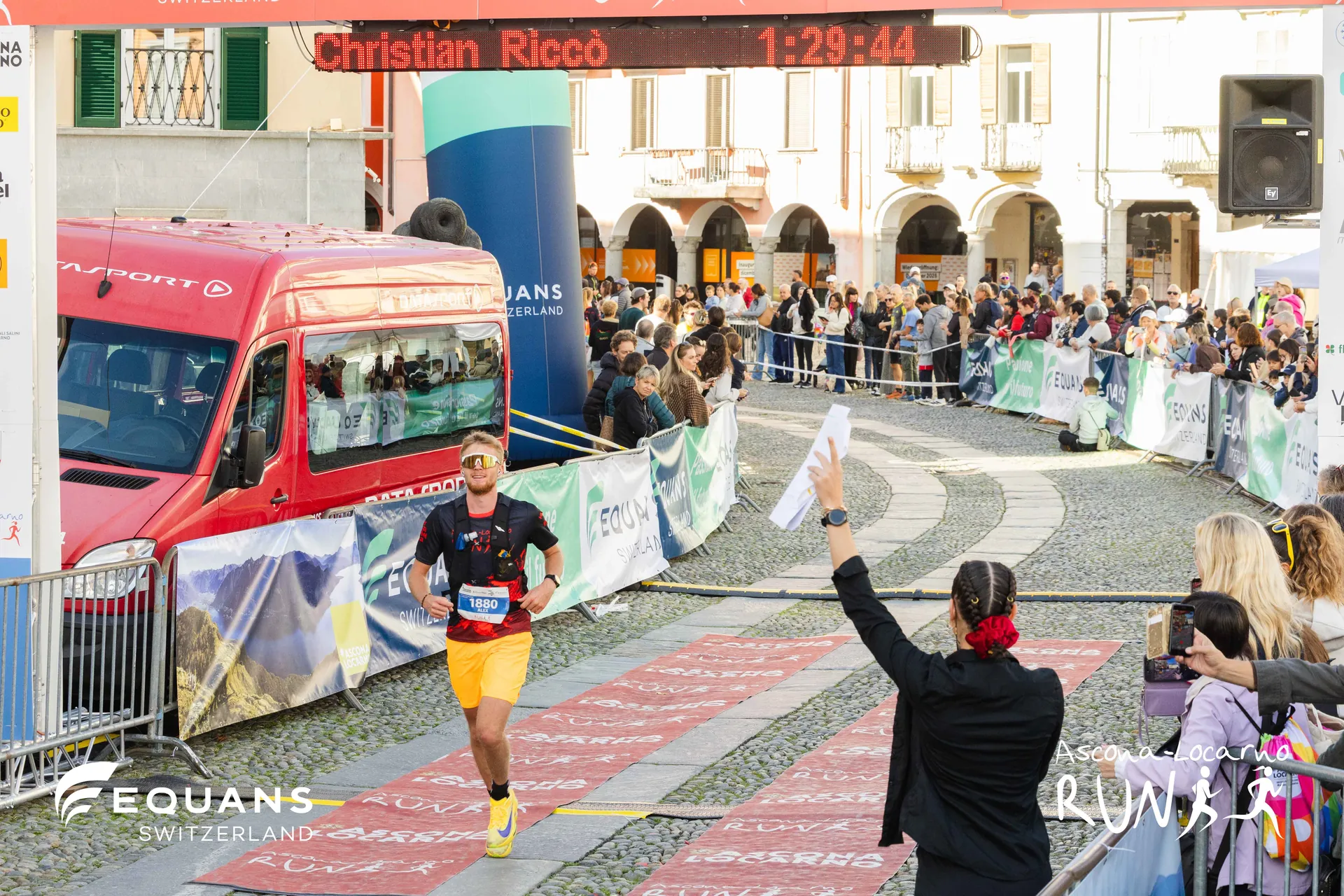 Ladina Ziani cheering a runner across the finish line at the Ascona-Locarno Run