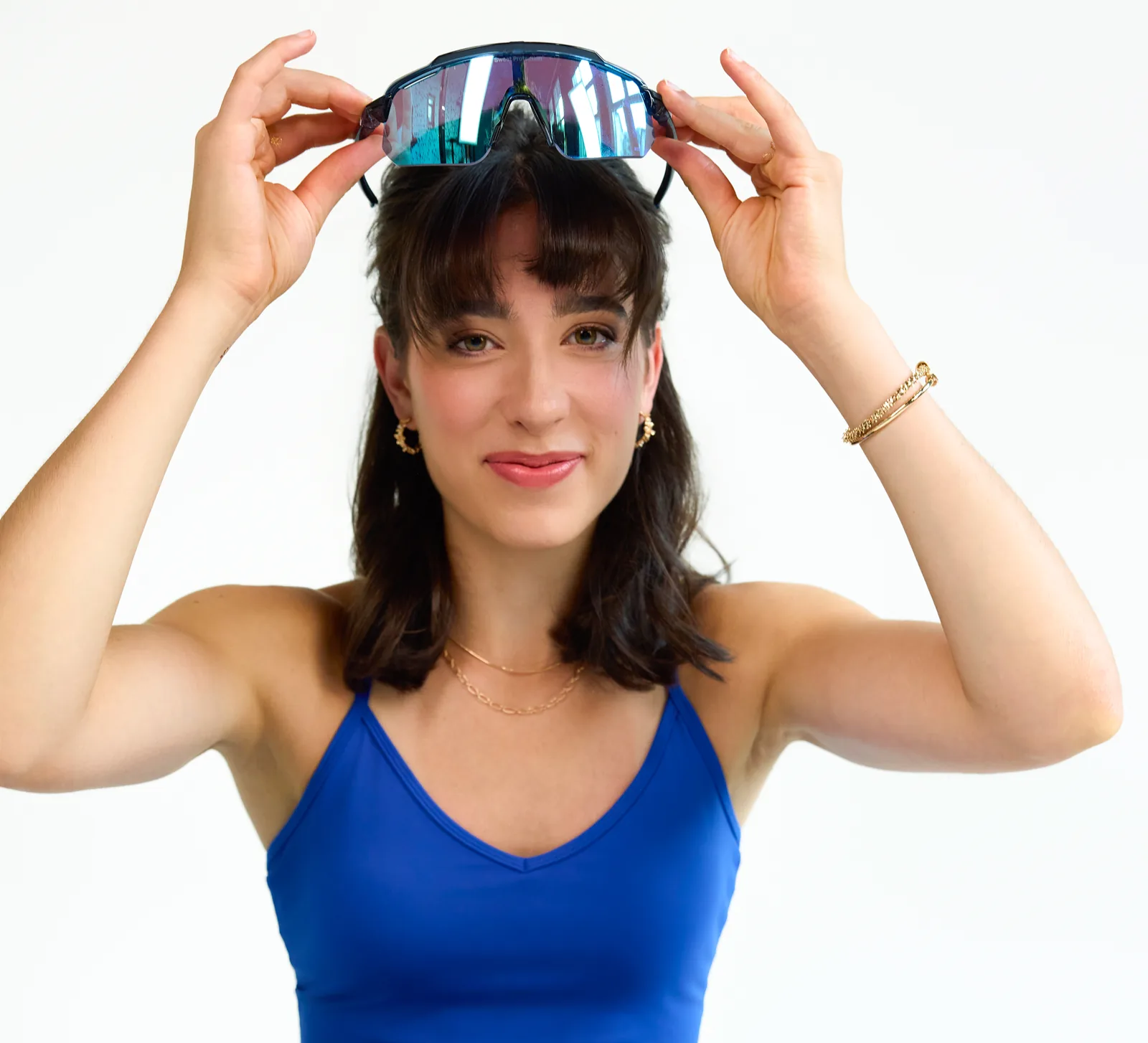 Portrait of Ladina Ziani smiling, holding sports sunglasses on her head