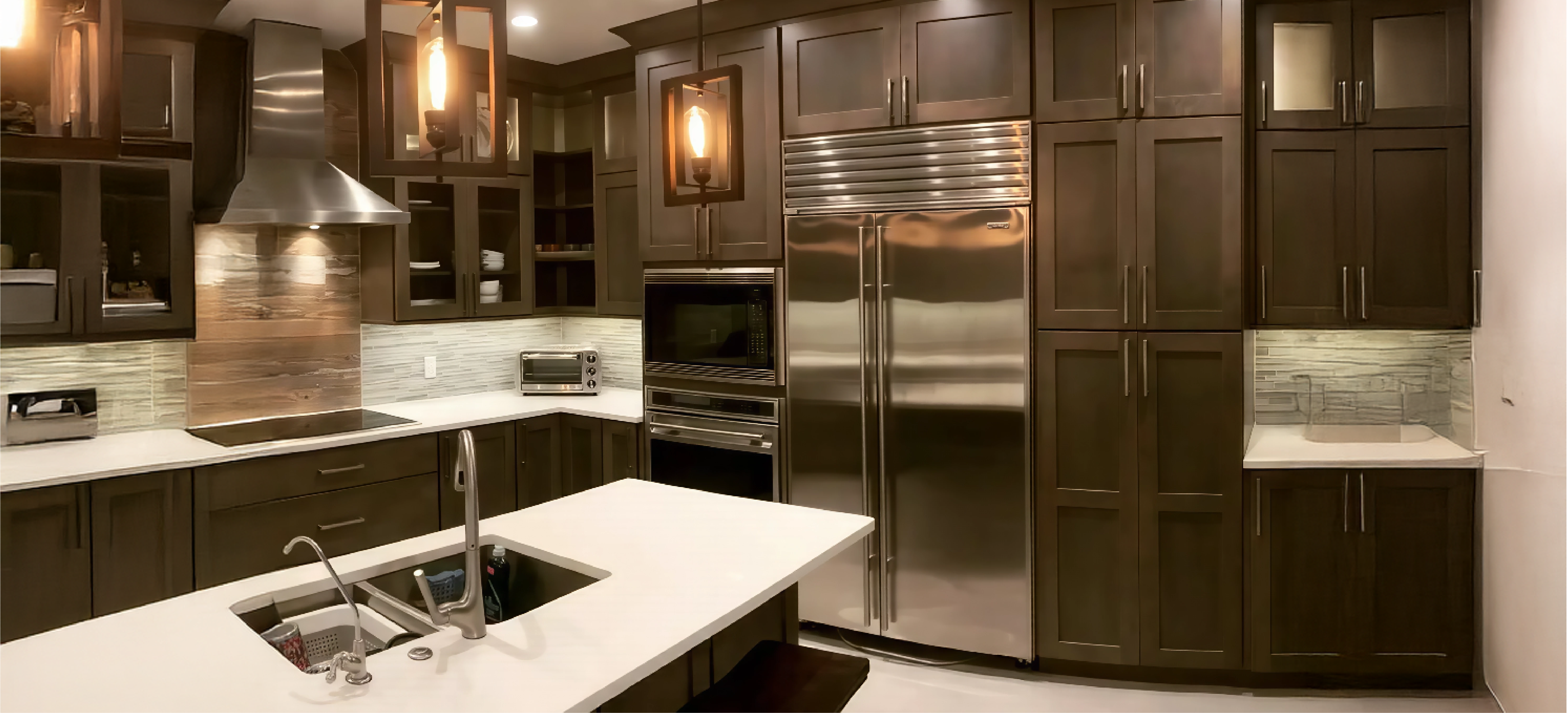 Modern industrial kitchen in Tampa, FL, featuring full-height dark wood cabinetry, professional stainless steel appliances, and integrated Sub-Zero refrigerator by Gonzo Interiors.