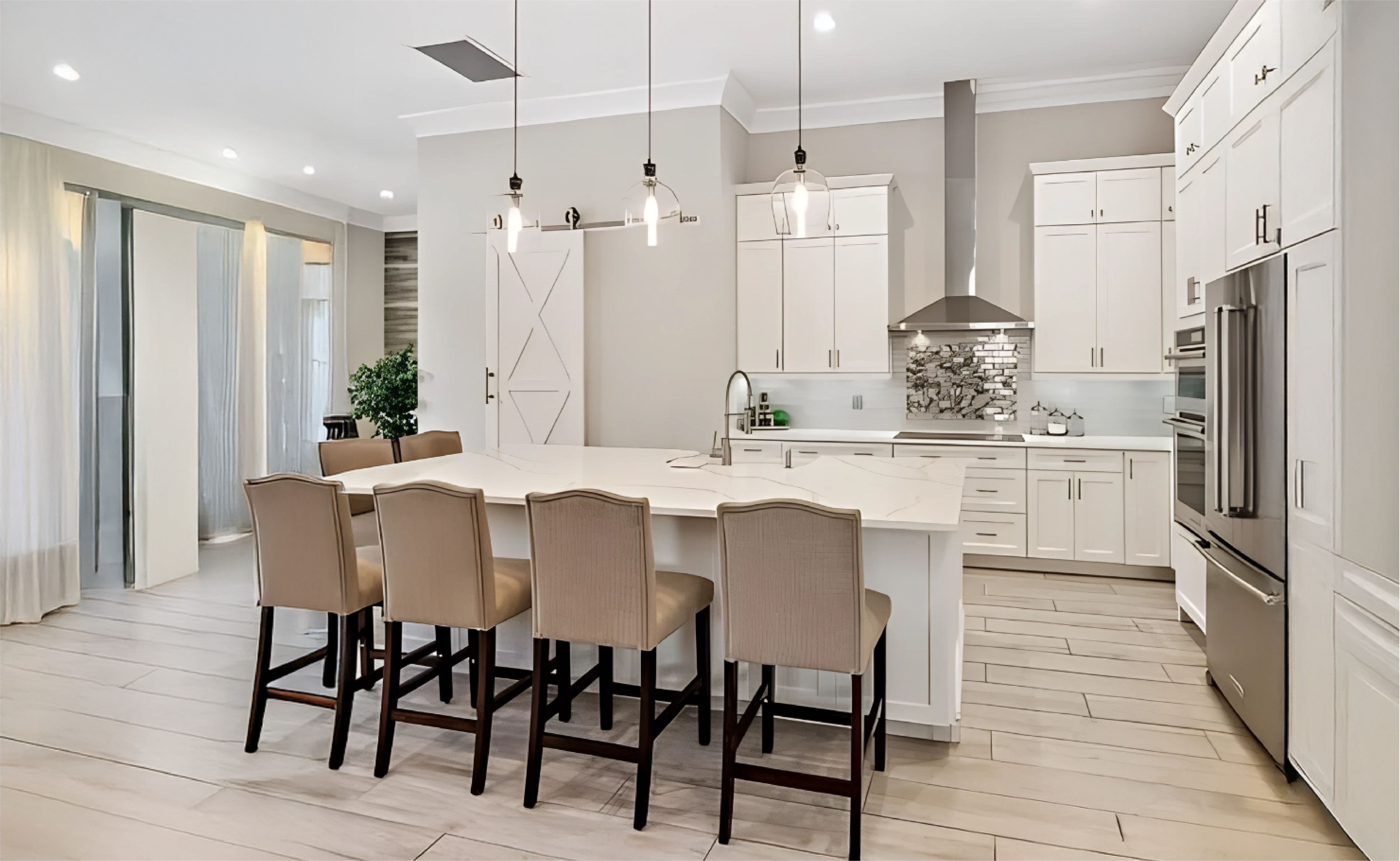 Luxury open-concept white kitchen with a large central island, integrated wine cooler, and professional interior lighting by Gonzo Interiors.