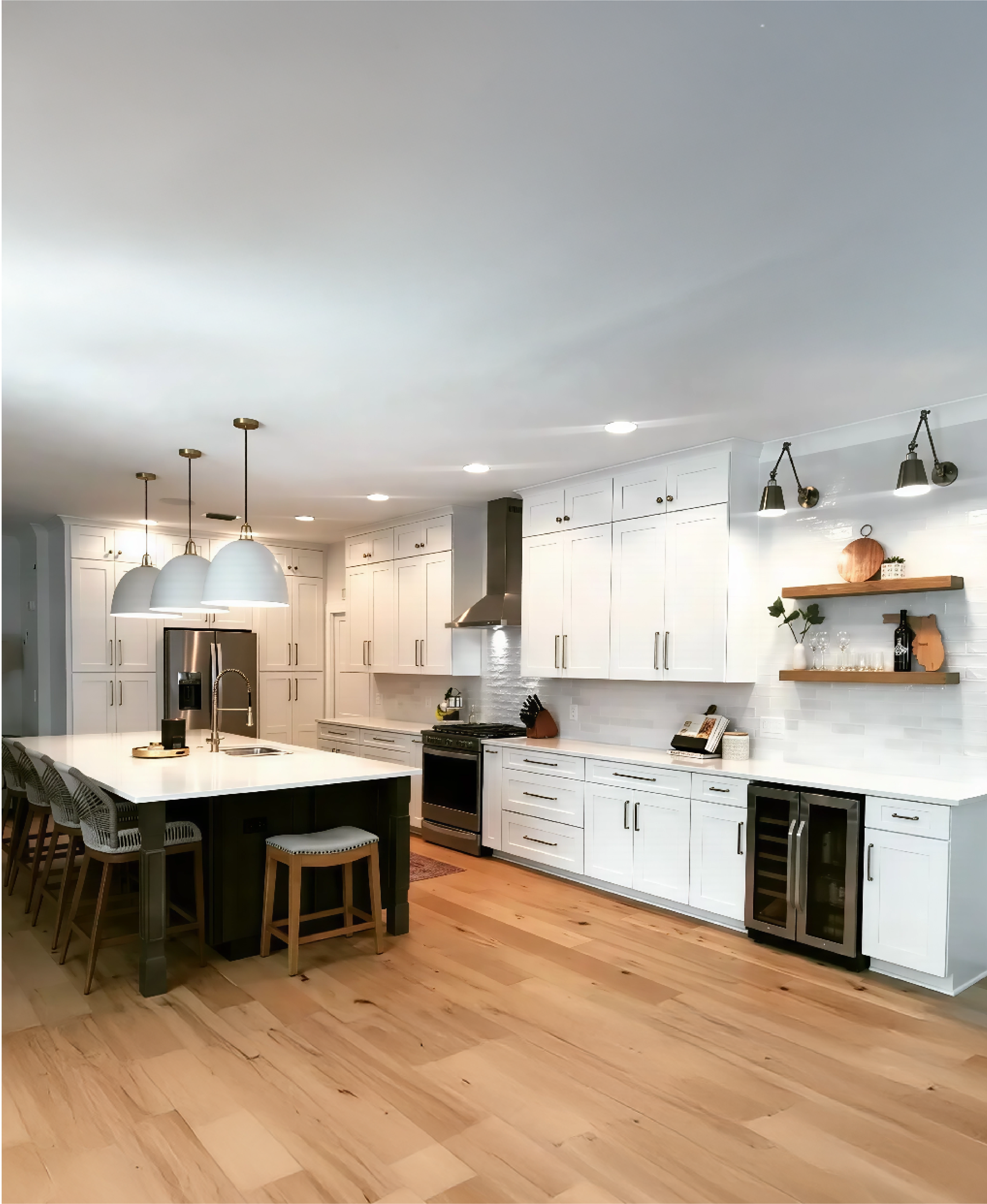 Luxury kitchen cabinetry design by Gonzo Interiors with shaker style cabinets, integrated wine cooler, and elegant glass pendant lighting