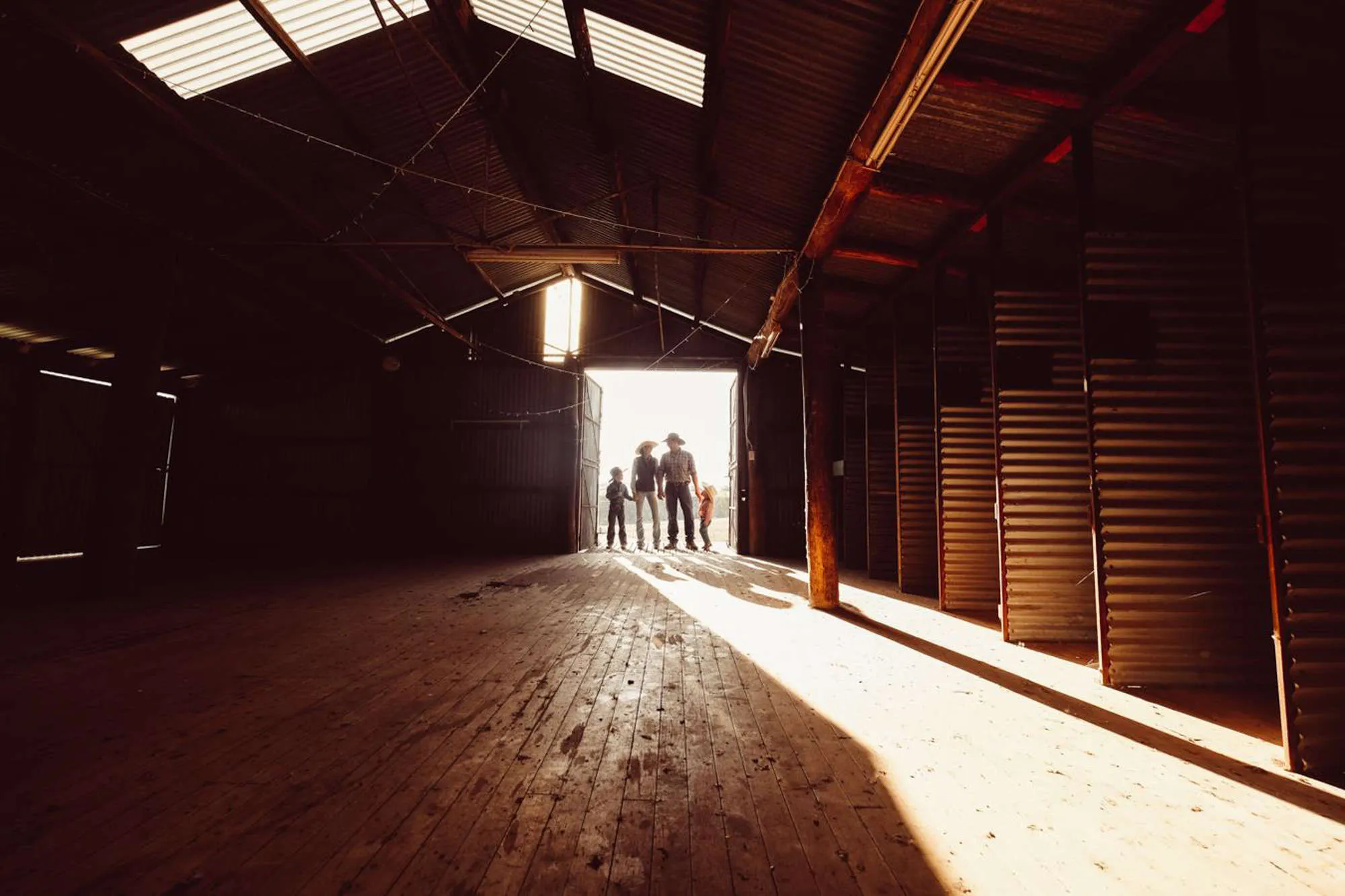 Family standing in the doorway of a shearing shed