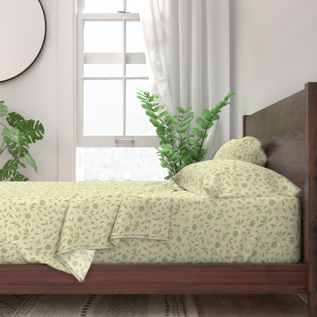 Green flowers and leaf shapes on a cream background pattern mockup of a set of sheets on wood-frame bed