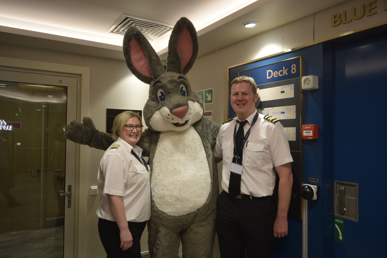 Truffles is onboard a ship, posing with the captain