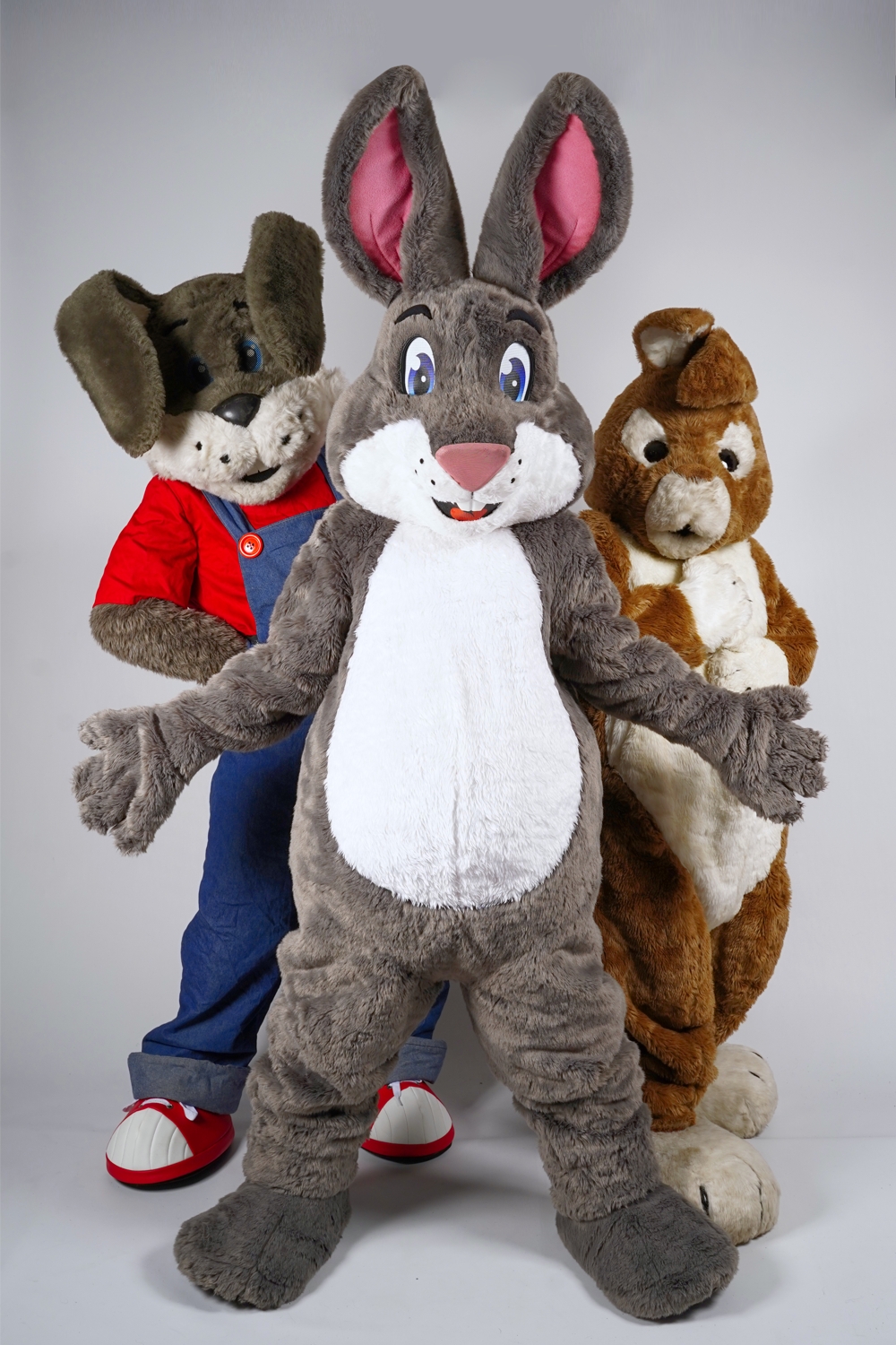 Three of our easter bunnies, Benny, Truffles and Clover, are stood in a group. Truffles has his arms out, Benny has his paws on his sides, and Clover has her paws on her chest.