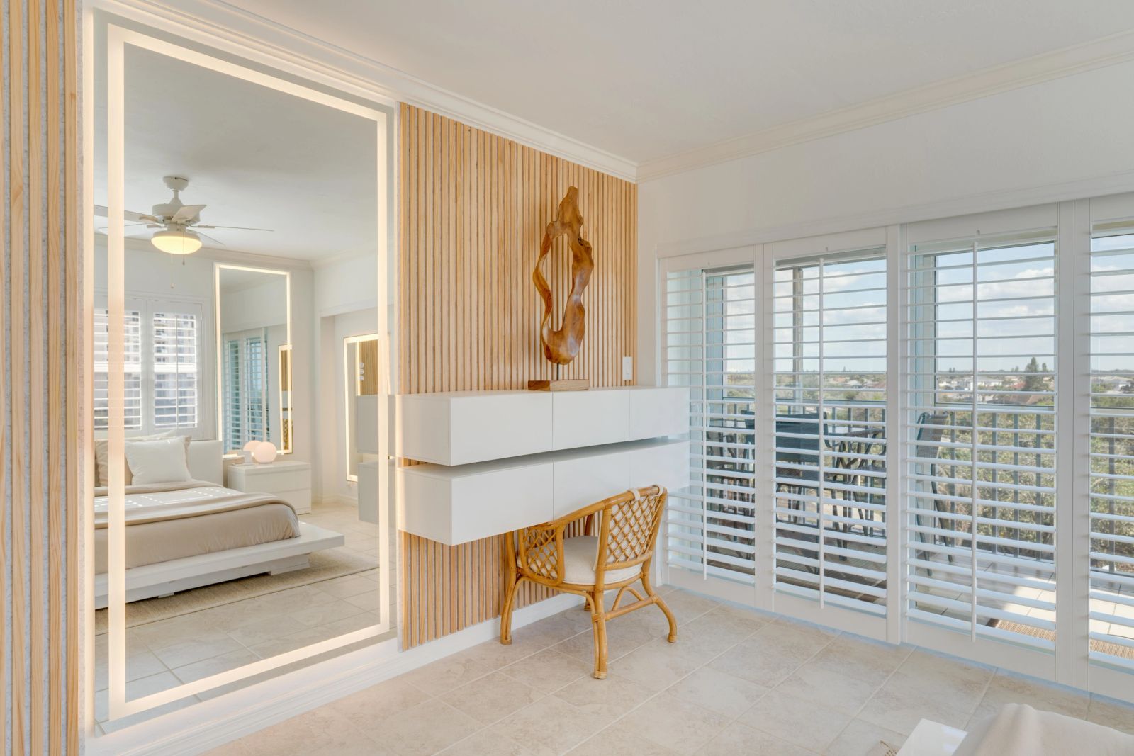 Sculptural artwork beside a mirrored bedroom vanity